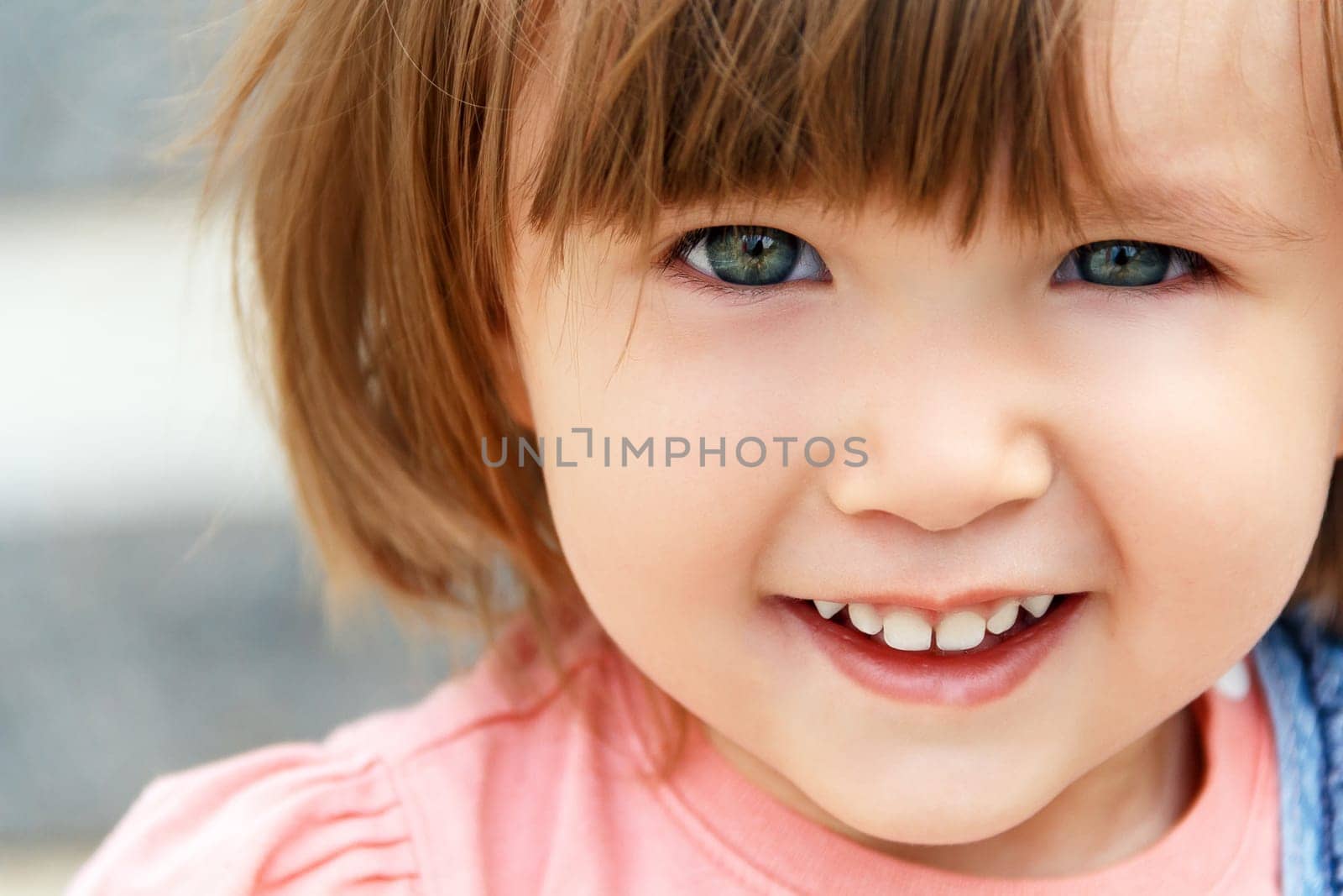 Photo of cute smiling Caucasian girl with short hair