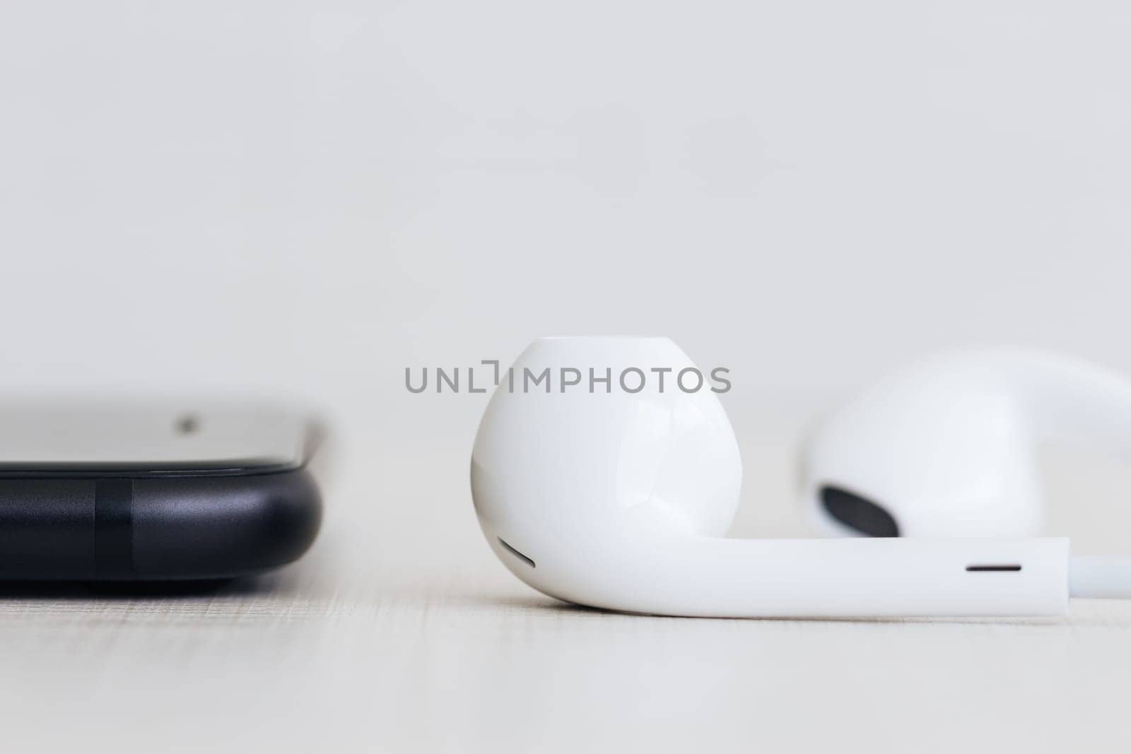 phone and headphones on wood side view