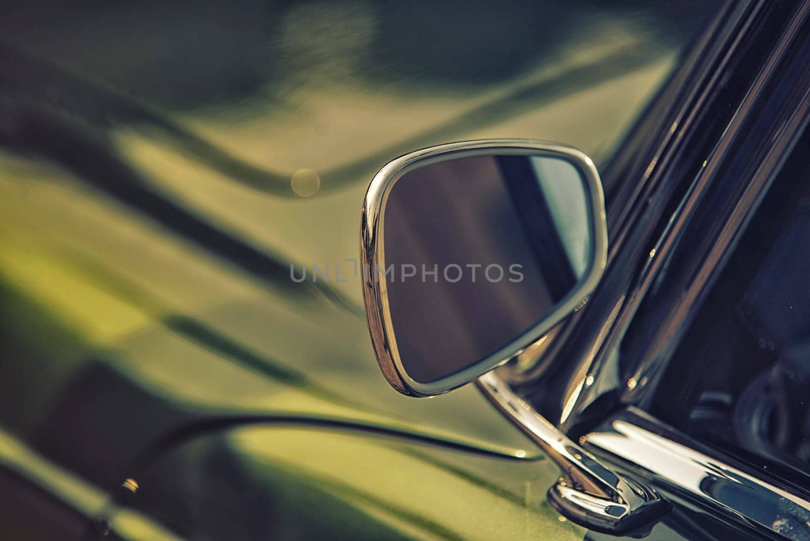 close up on rear view mirror on greenv intage car.