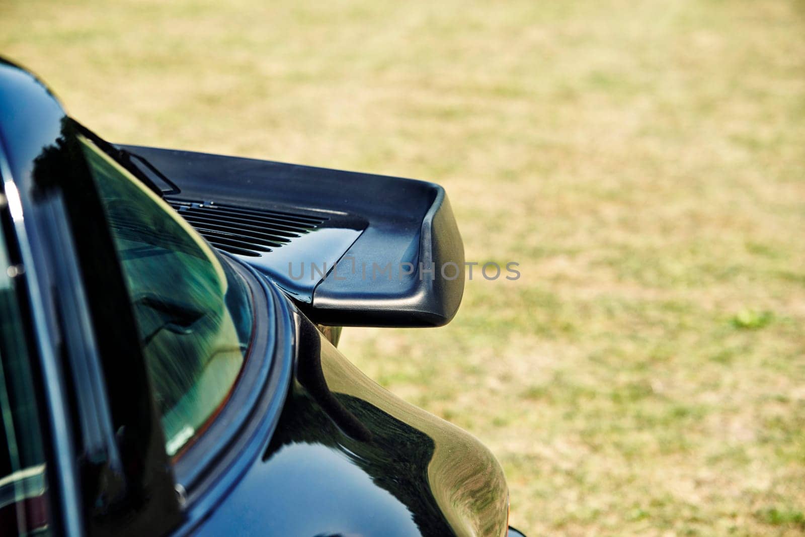 close up on dark blue sports car spoiler