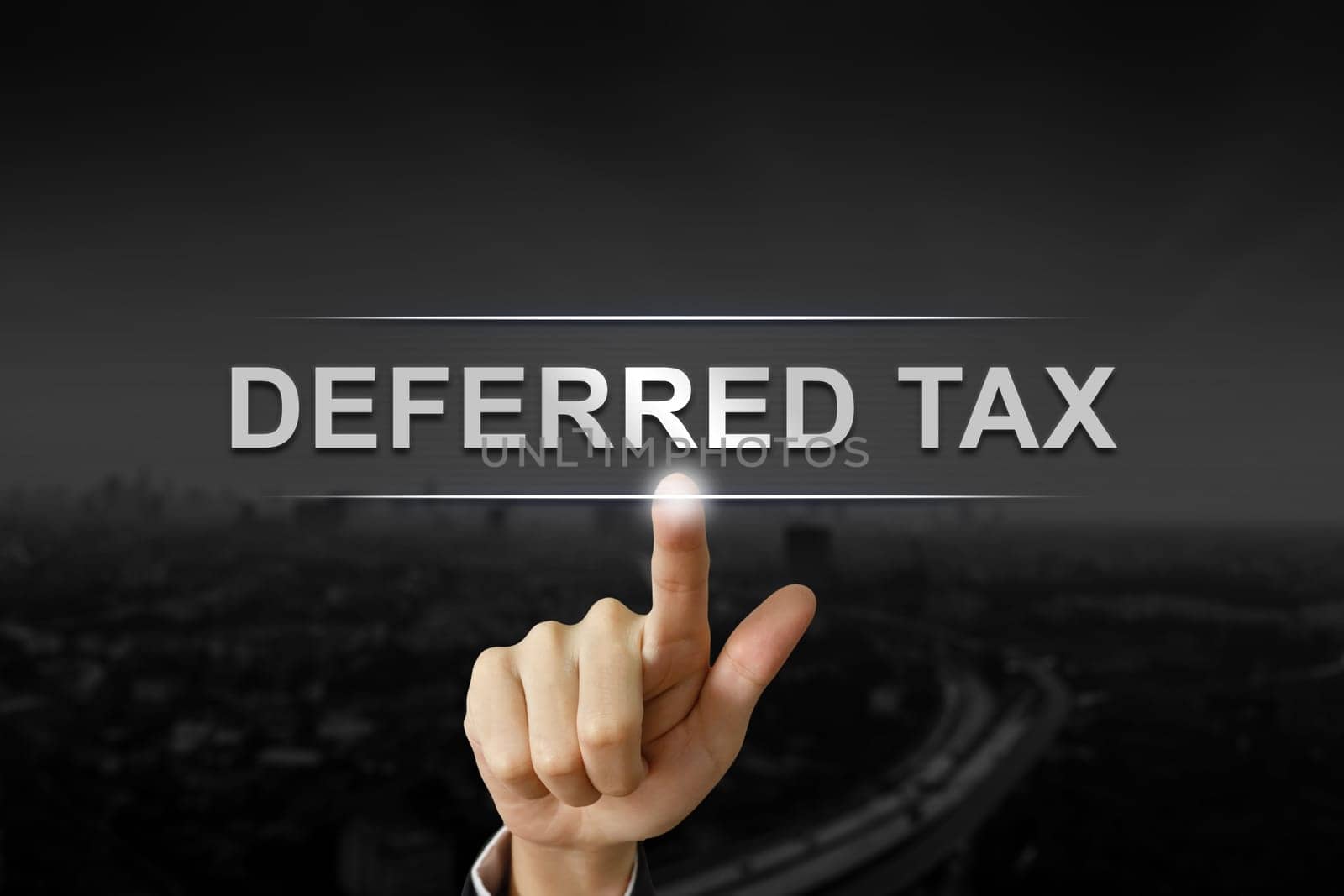 business hand clicking deferred tax button on black blurred background