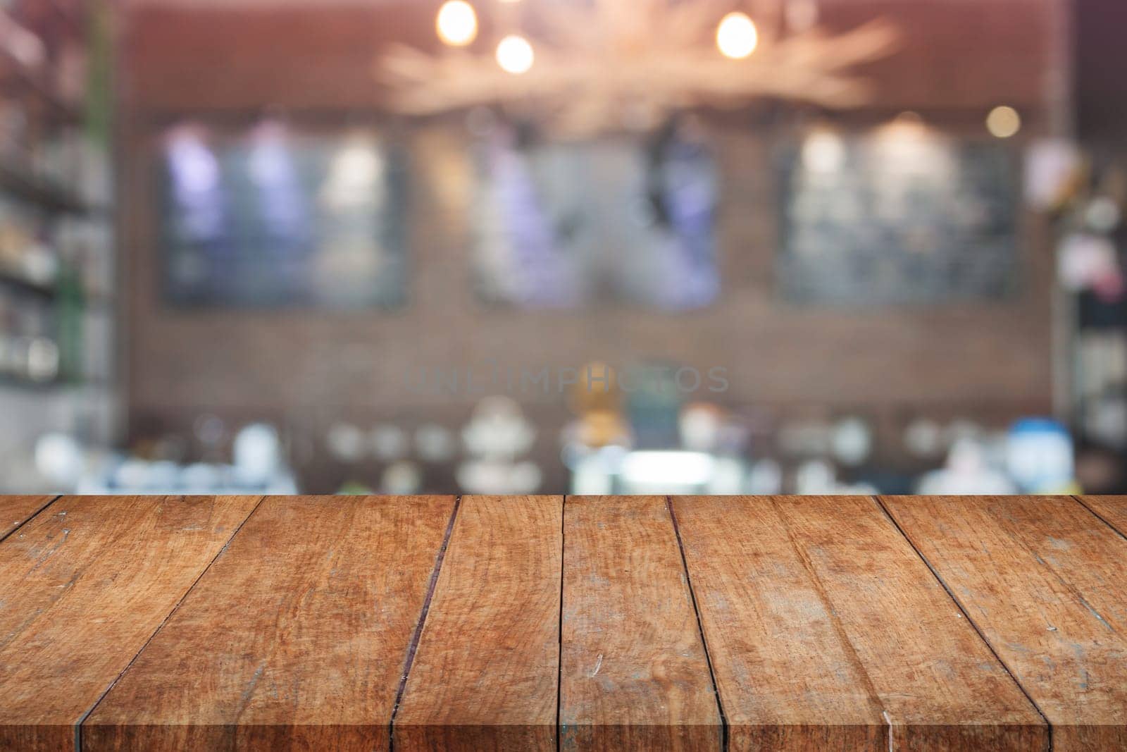 Brown wooden table top with blurred cafe. product display template