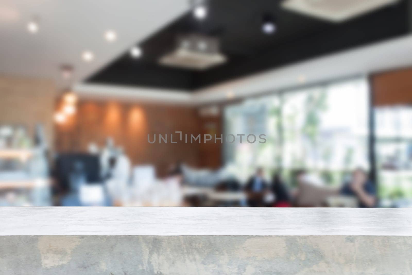 Concrete table top with blurred cafe interior for background
