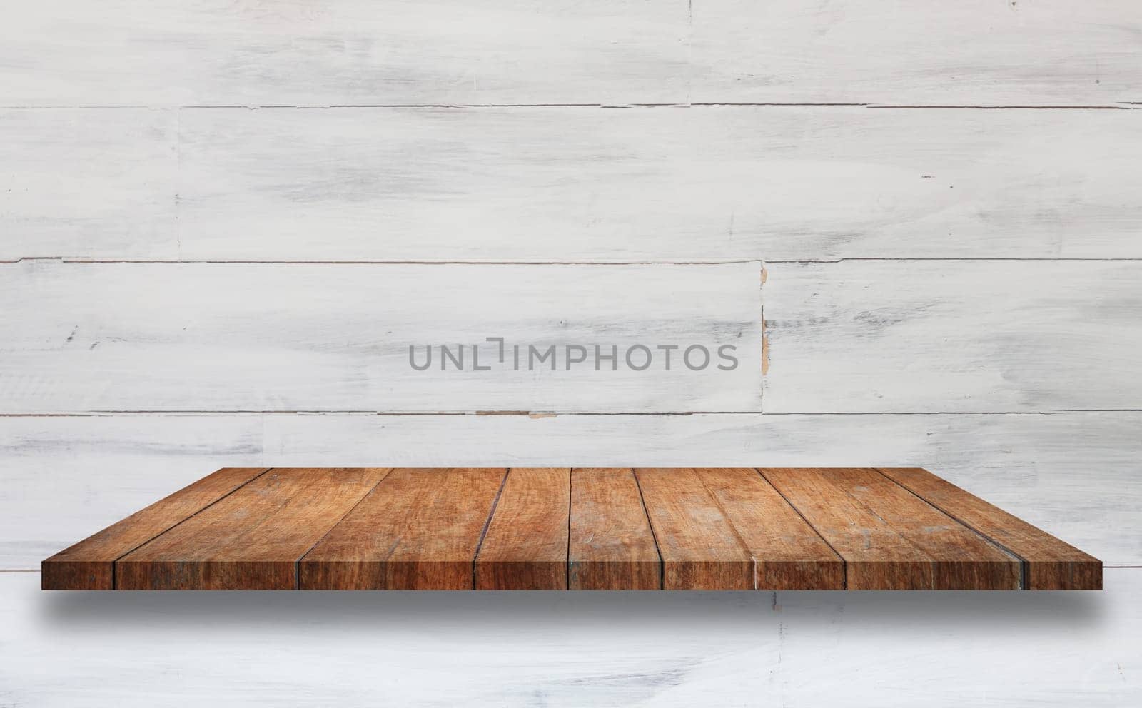 Top of brown wooden shelf with white wooden wall background. For product display