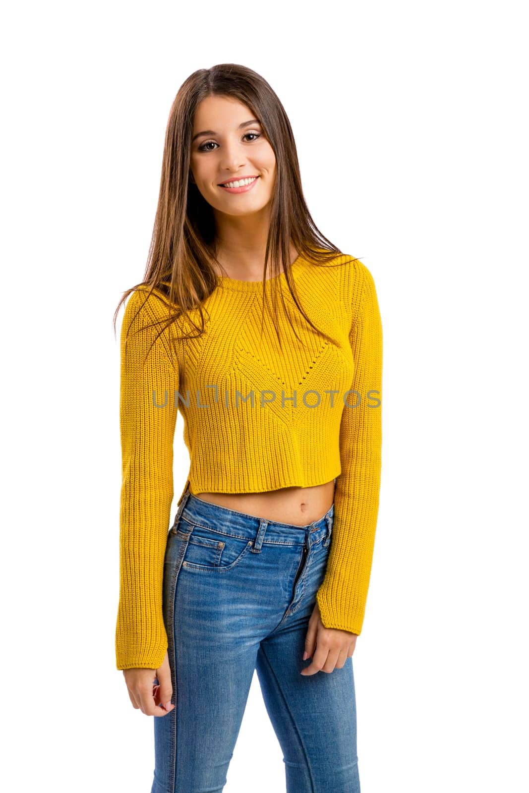 Beautiful and happy teenage girl pointing, isolated over white background