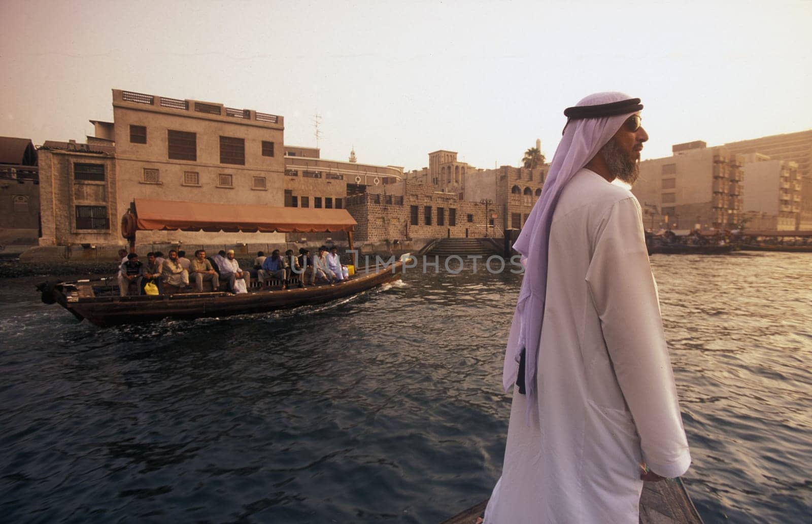 a city boat and ferry on the Dubai creek in the old town in the city of Dubai in the Arab Emirates in the Gulf of Arabia.