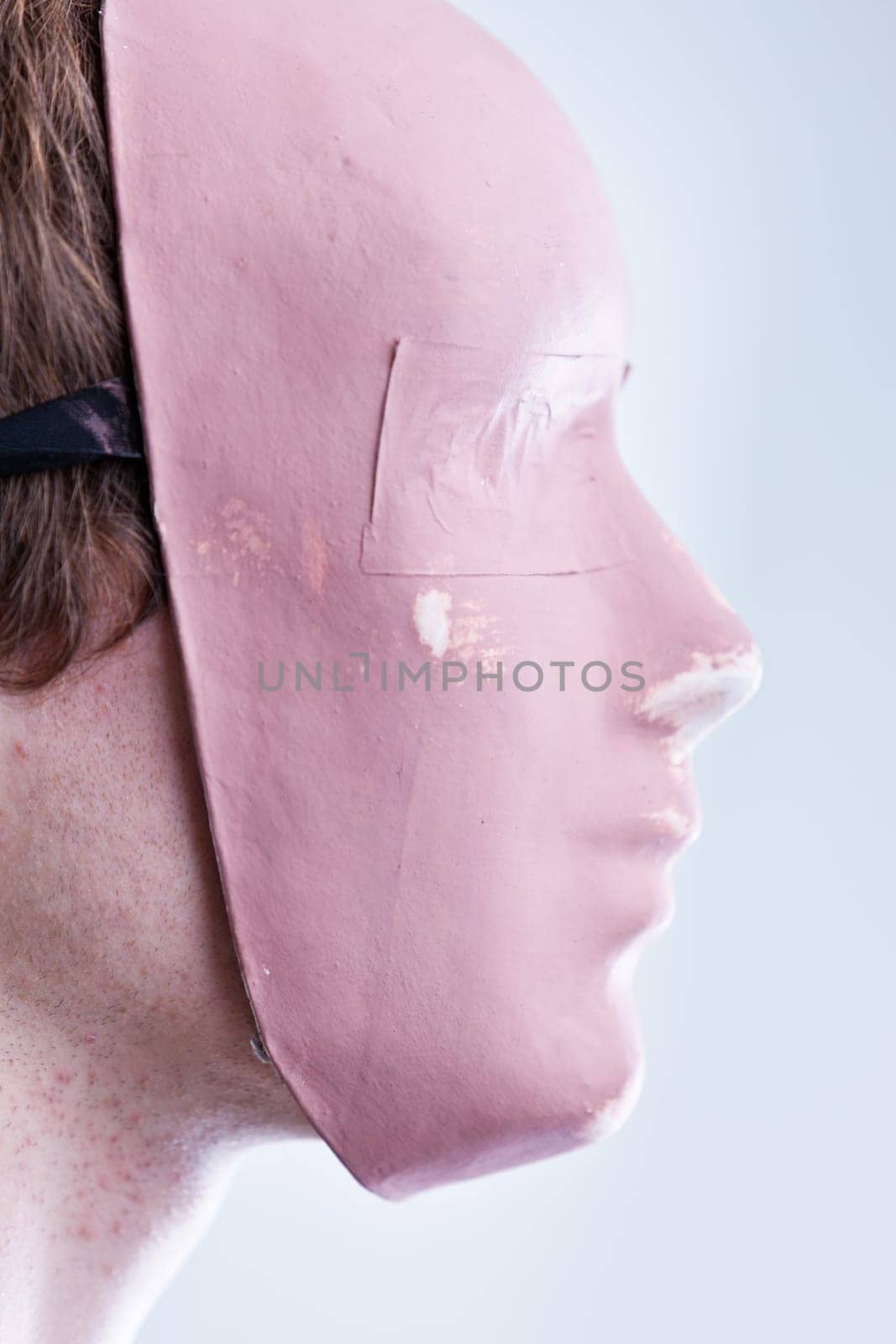 man with mask in a foreground portrait brightly lit