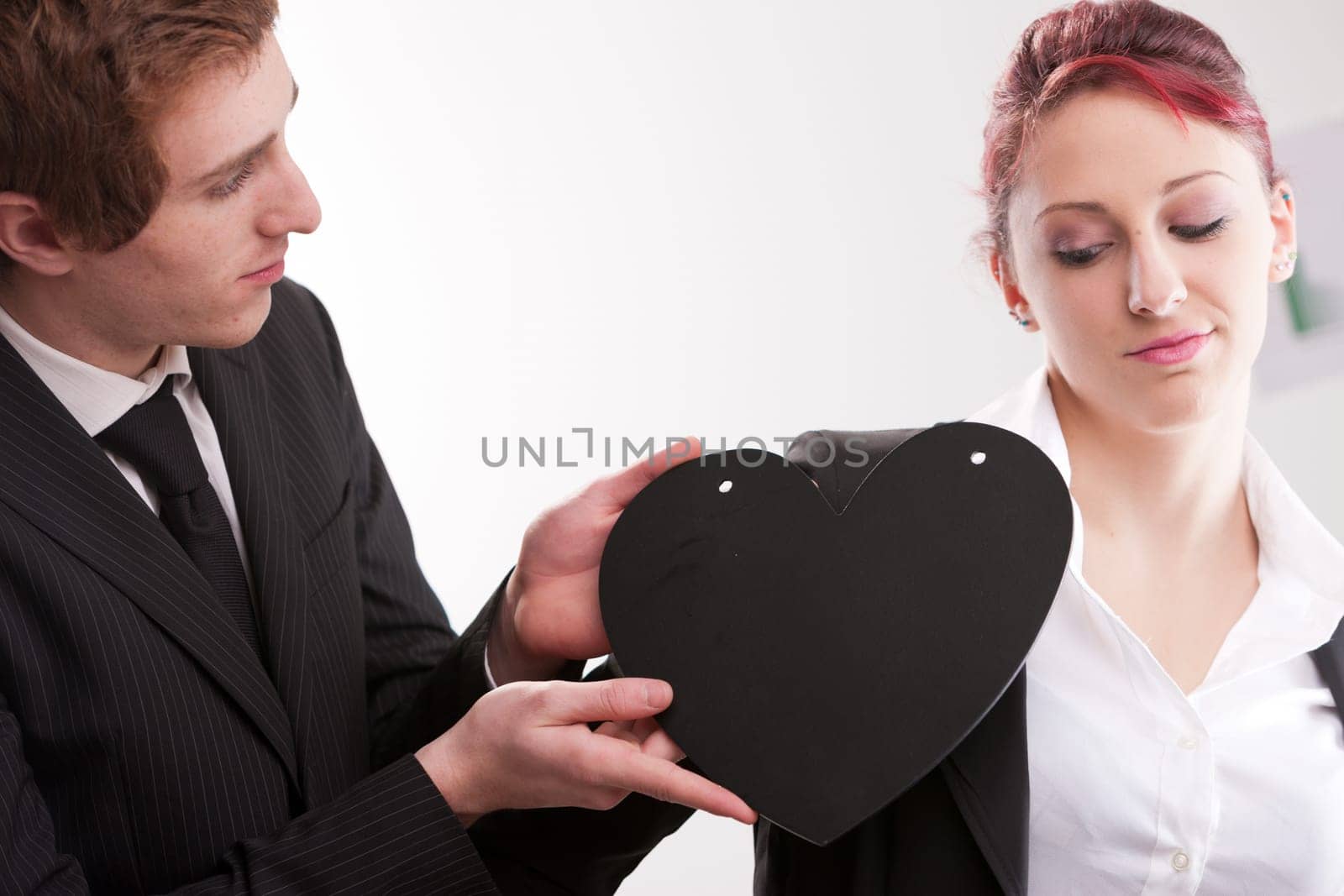 business man loving busines woman and offering a heart