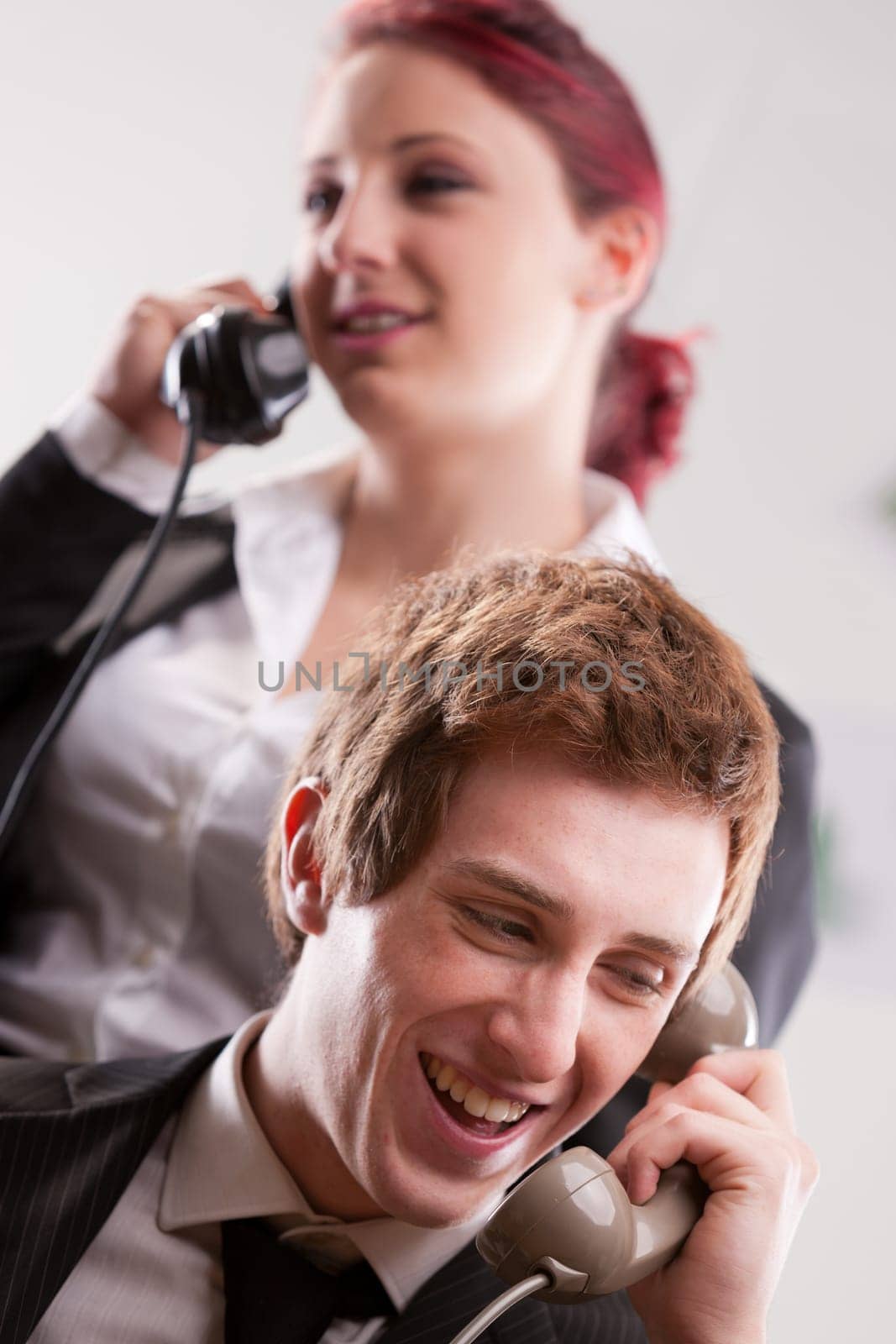smiling office workers in a call center with phones