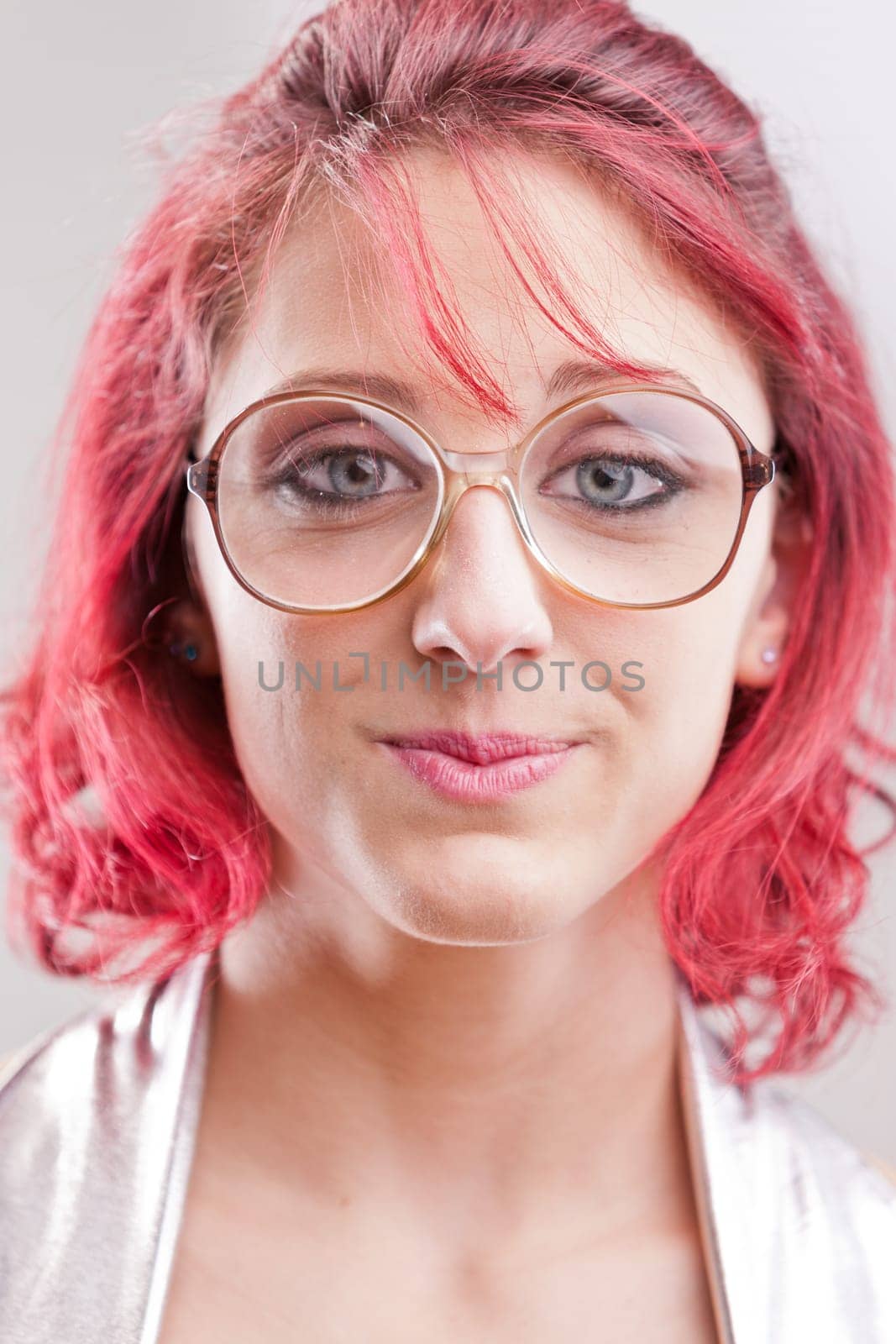 red haired girl with big glasses and a funny candid expression