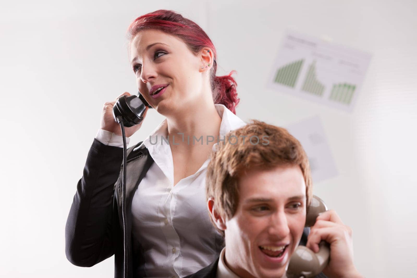 smiling office workers in a call center with phones