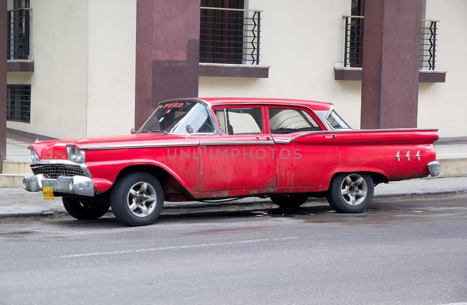 Old classic american cars drived along the street at the Havana old town
