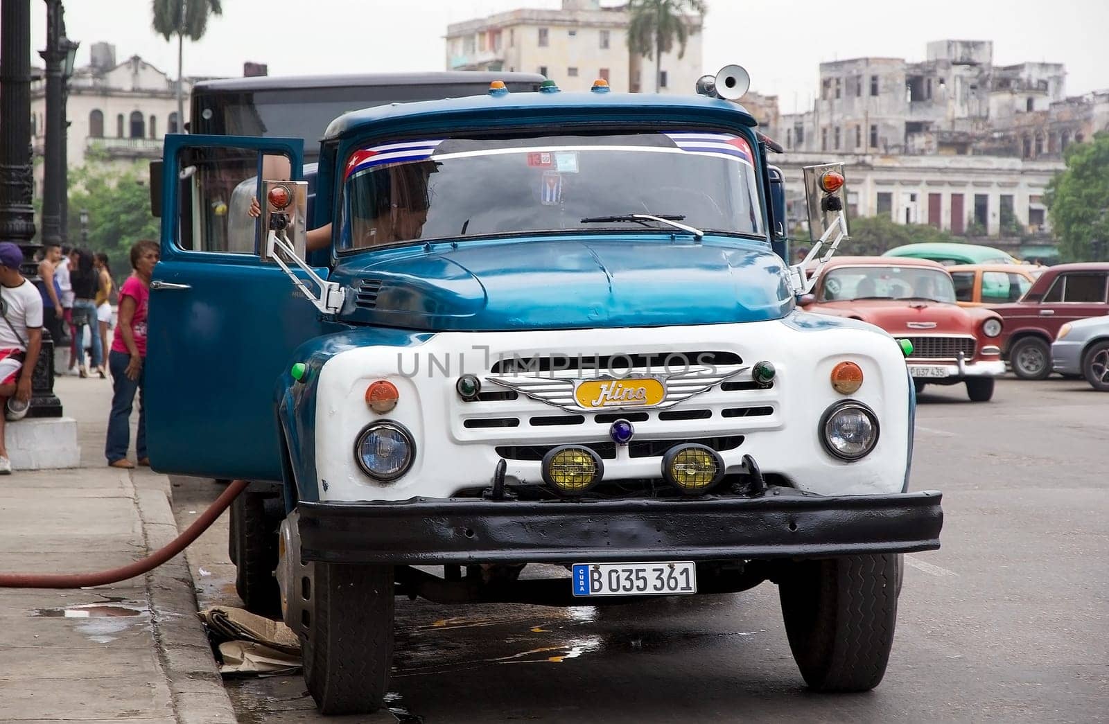 cuban man is driving the old classic lorry along the street at the Old Havana