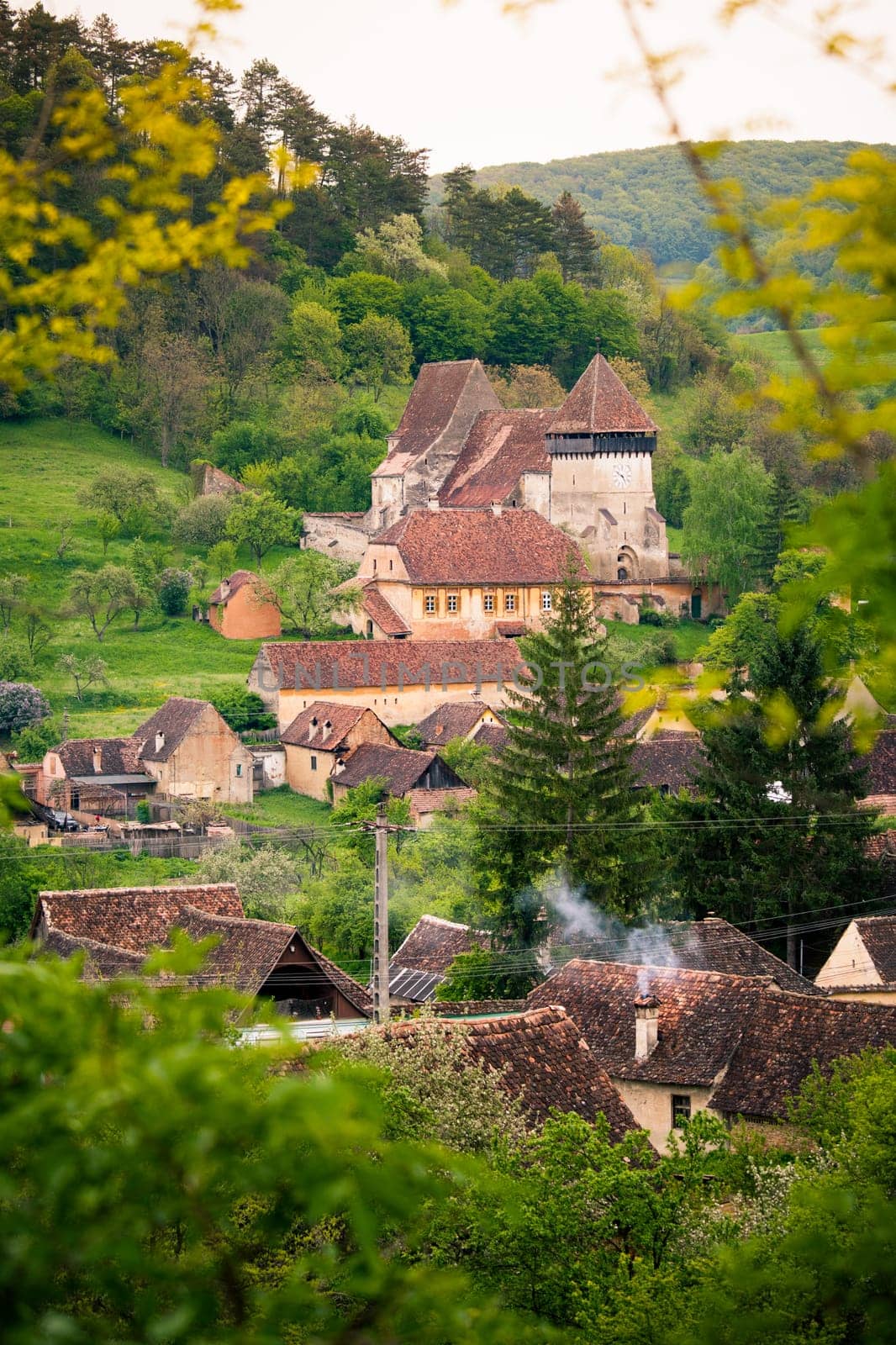 Street view of medieval Saxon village of copsa mare with fortified church  in Romania .In Transylvania region