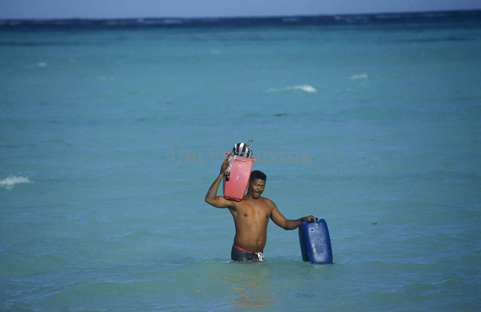 A Fisherman on the way from the Boat to the Village of Las Terrenas on Samanaon in The Dominican Republic in the Caribbean Sea in Latin America.