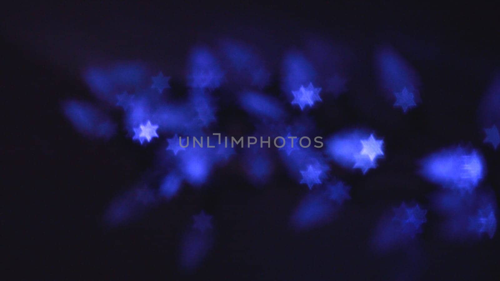 Beautiful bokeh lights in shape of the Star of David for Hanukkah celebration. Jewish Holiday background.
