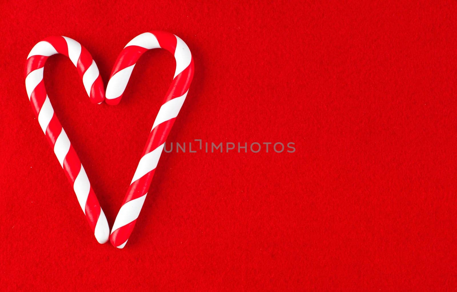 Valentine Heart made from Christmas candies isolated on black background