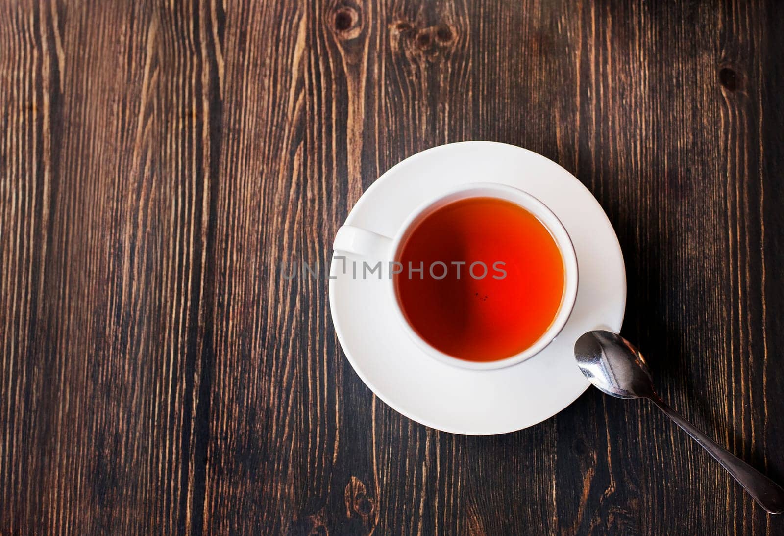 Cup of tea on wooden table. Free advertising space...
