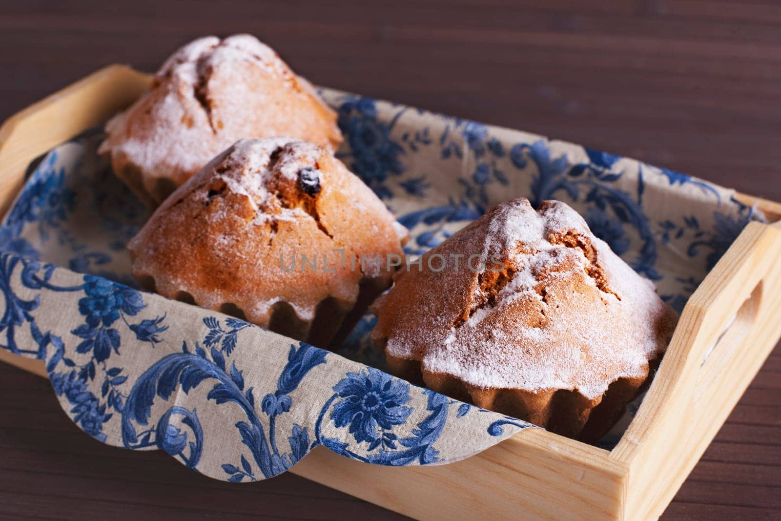 Muffin cakes in wooden tray.  Stock image.