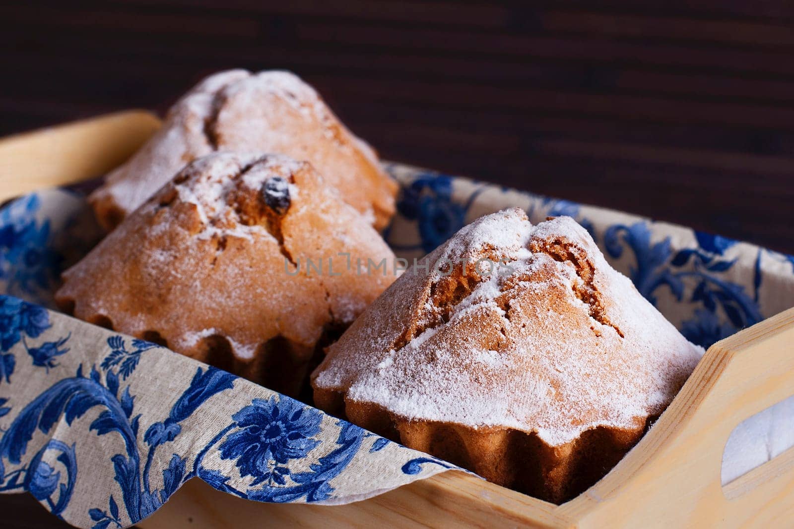 Muffin cakes in wooden tray.  Stock image.