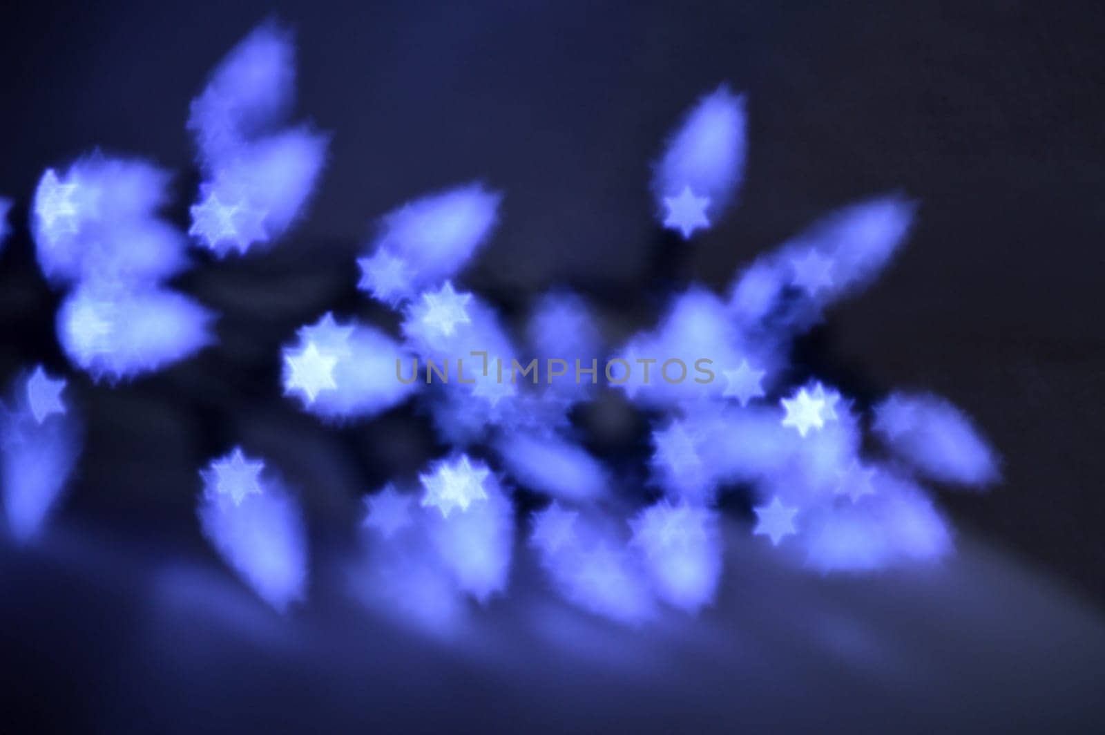 Beautiful bokeh lights in shape of the Star of David for Hanukkah celebration. Jewish Holiday background.