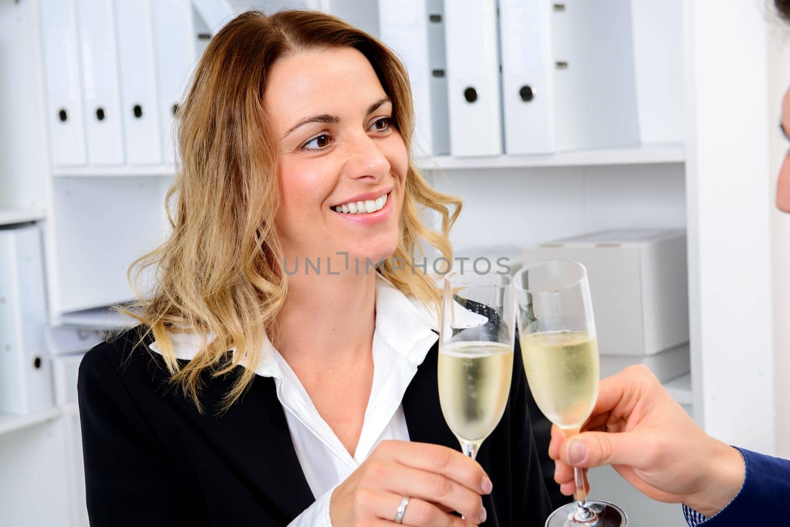 young businessman and businesswoman celebrating together in the office