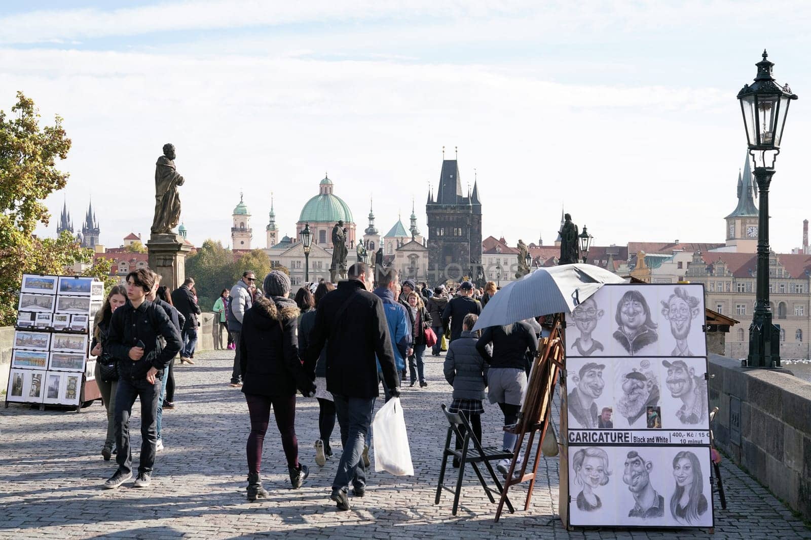Tourists and artists on Charles Bridge in Prague