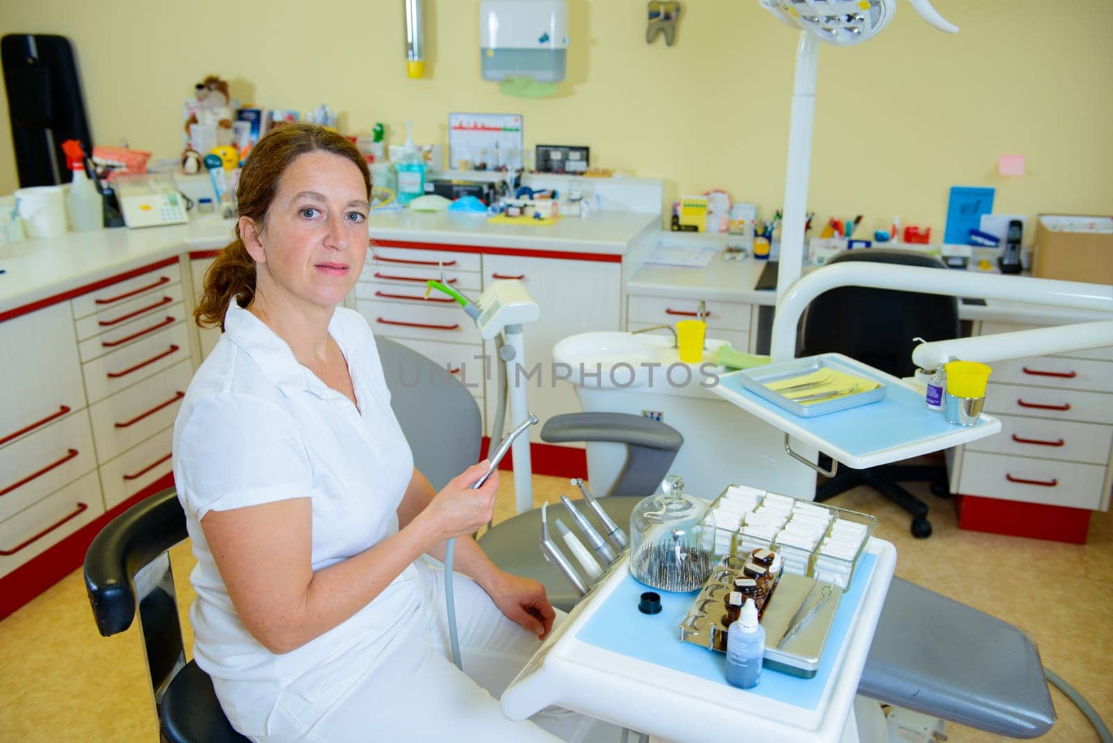 female dentist in dental surgery looking in to the camera