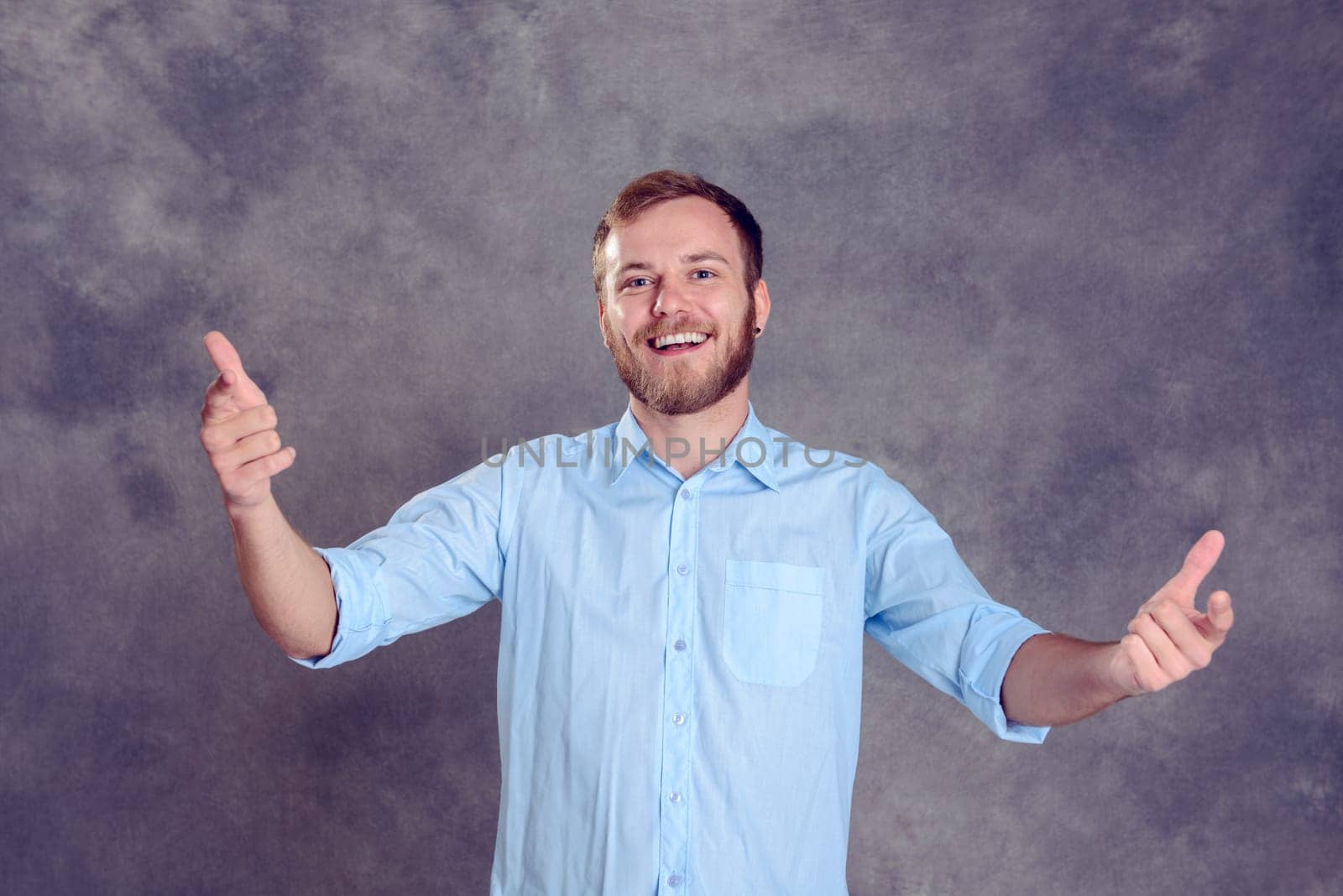 young bearded man is surprised and showing open hands