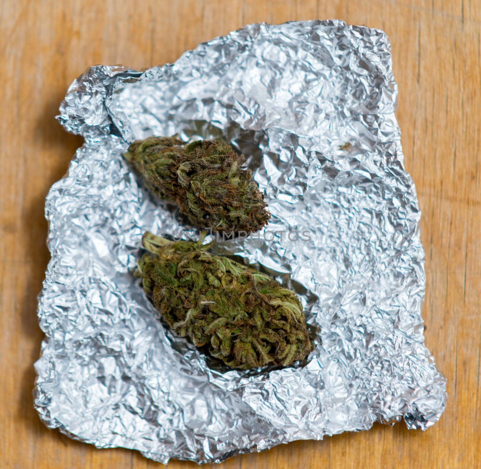 close up on marijuana in tin foil on table