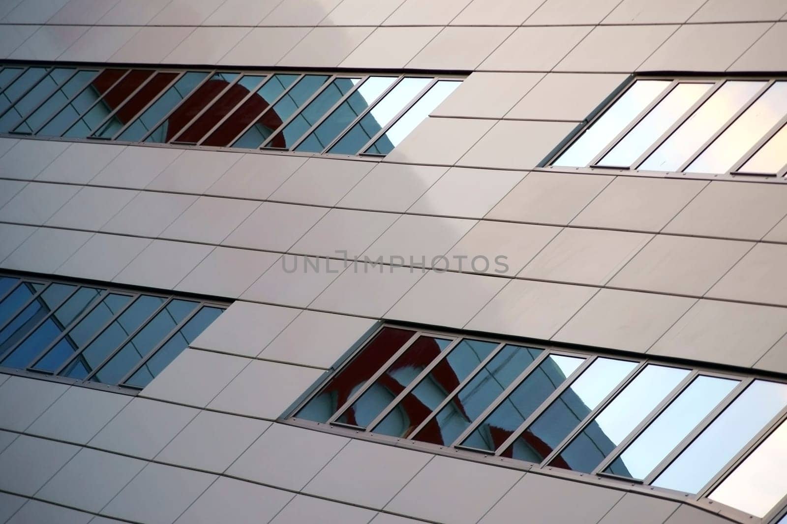 The modern rows of windows and façade cladding of an office and commercial building.