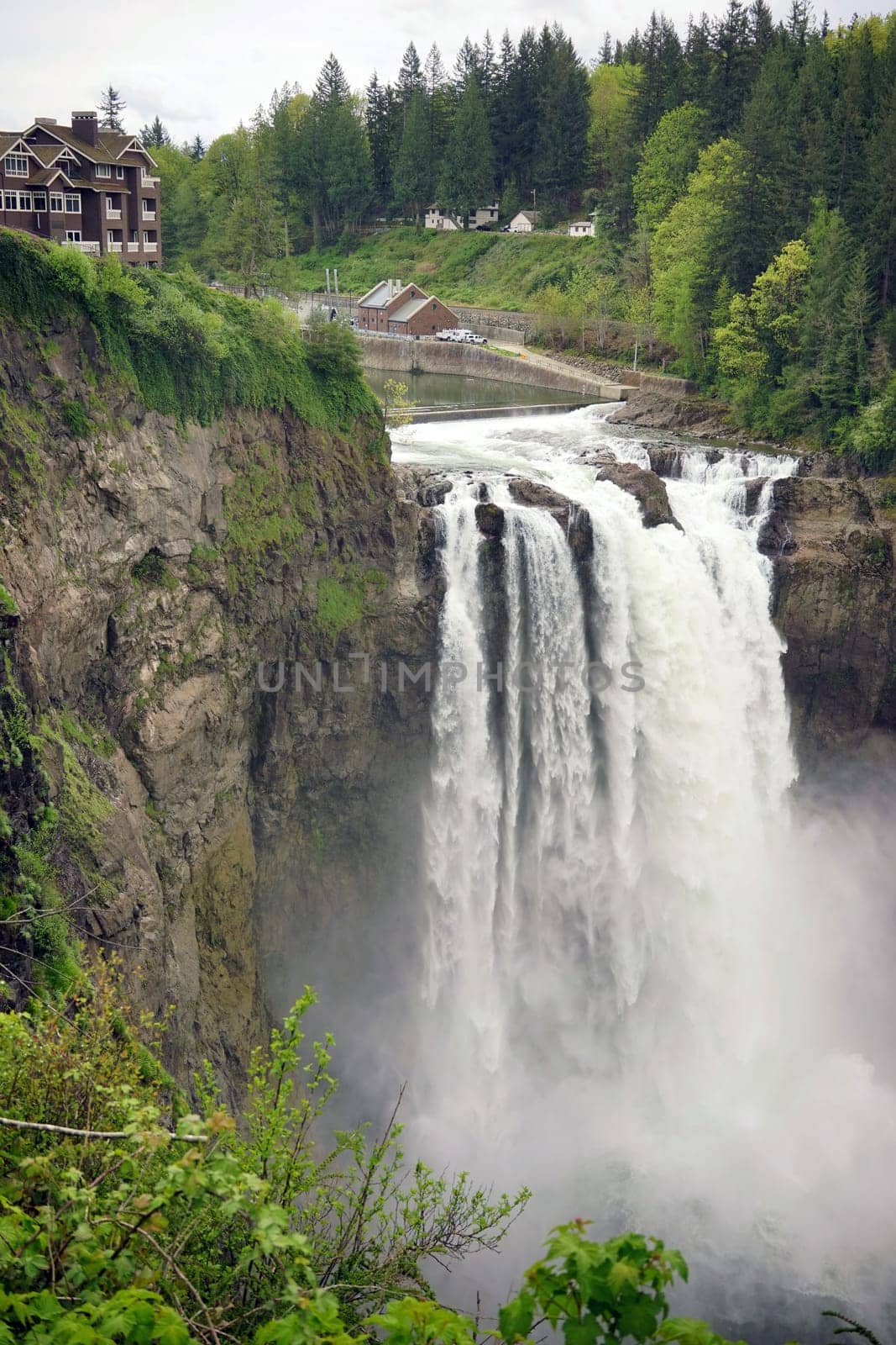 A large flow of water travels over the ridge creating a waterfall