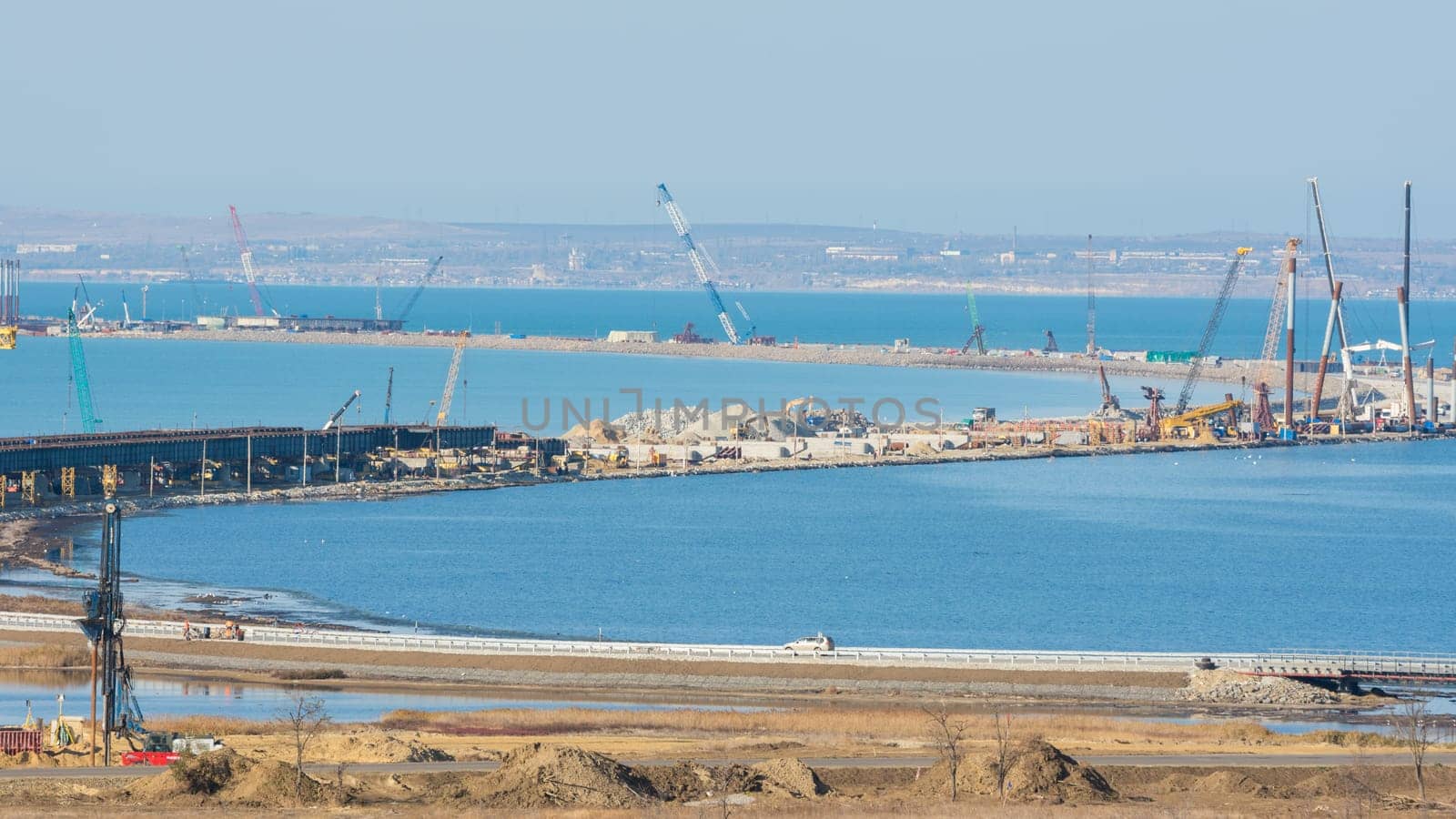 Taman, Russia - November 5, 2016: Construction of a bridge across the Kerch Strait, a view of the coastline and the connection Tuzla Spit from the Taman Peninsula, as of November 2016