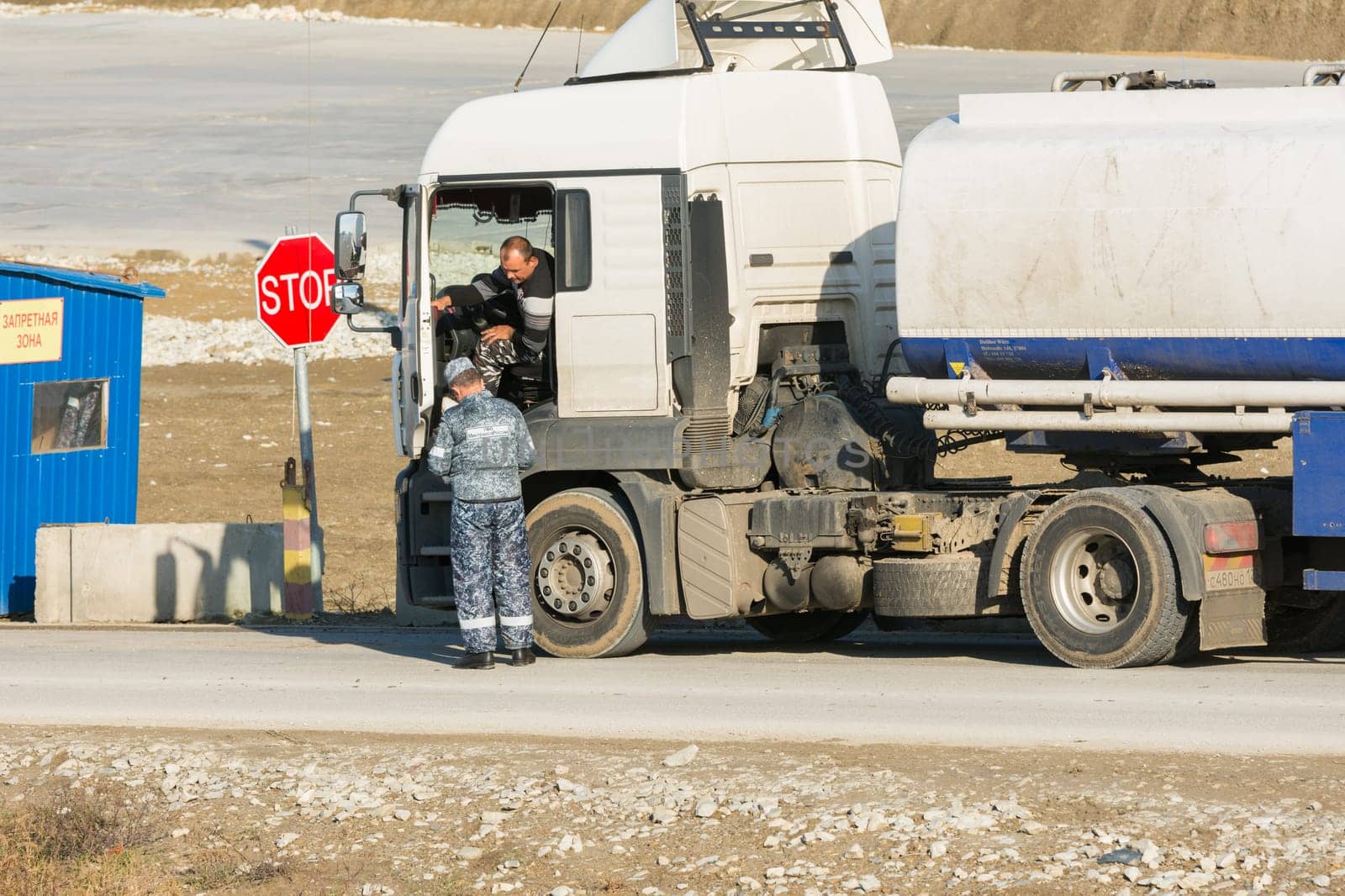 Taman, Russia - November 5, 2016: Verification of documents from the driver tank truck at security checkpoint at vezde the protected area