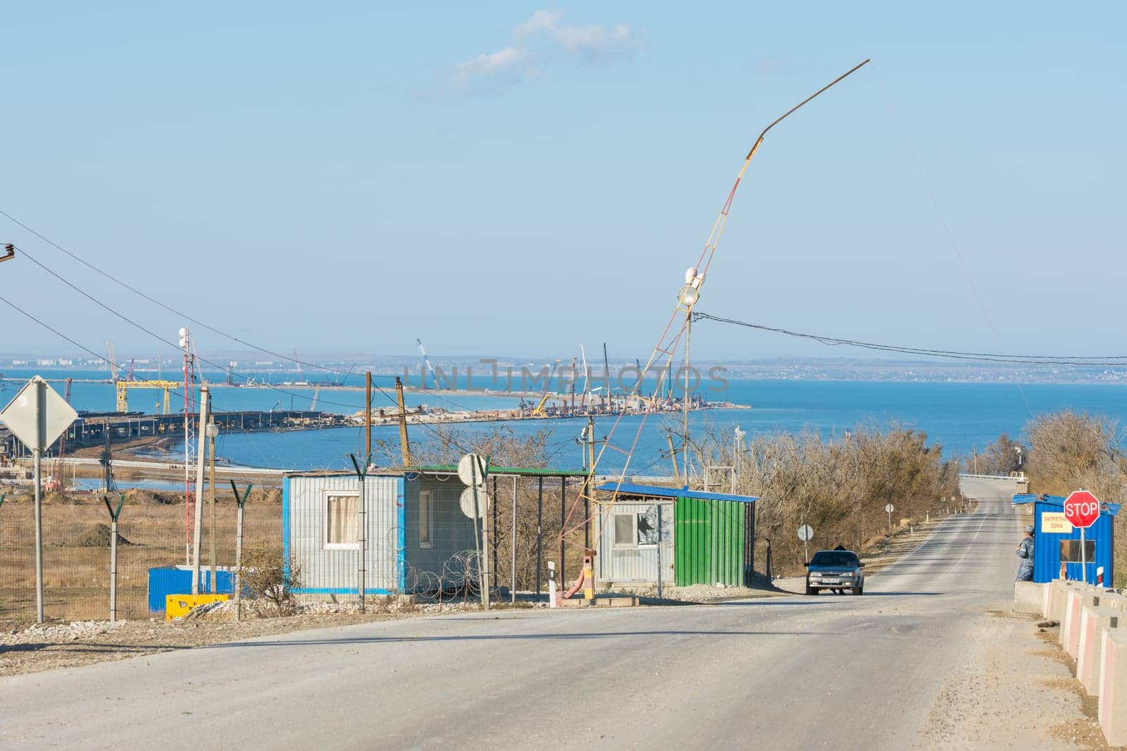 Taman, Russia - November 5, 2016: Construction of a bridge across the Kerch Strait, the control checkpoint on the road leading to the building, at the shoreline of the Taman peninsula, as of November 2016