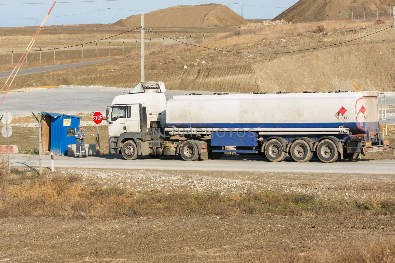 Taman, Russia - November 5, 2016: Verification of documents from the driver tank truck at security checkpoint protected area