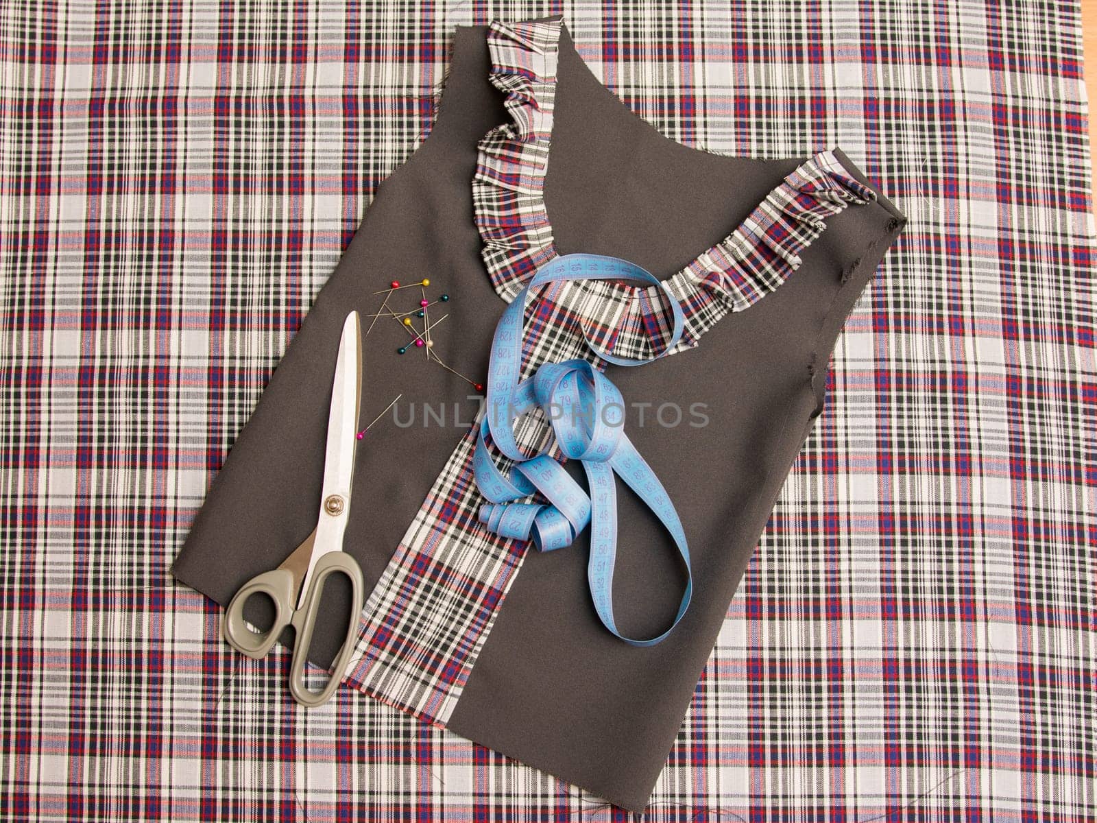 Top view of the workpiece and the children's school dress sewing supplies