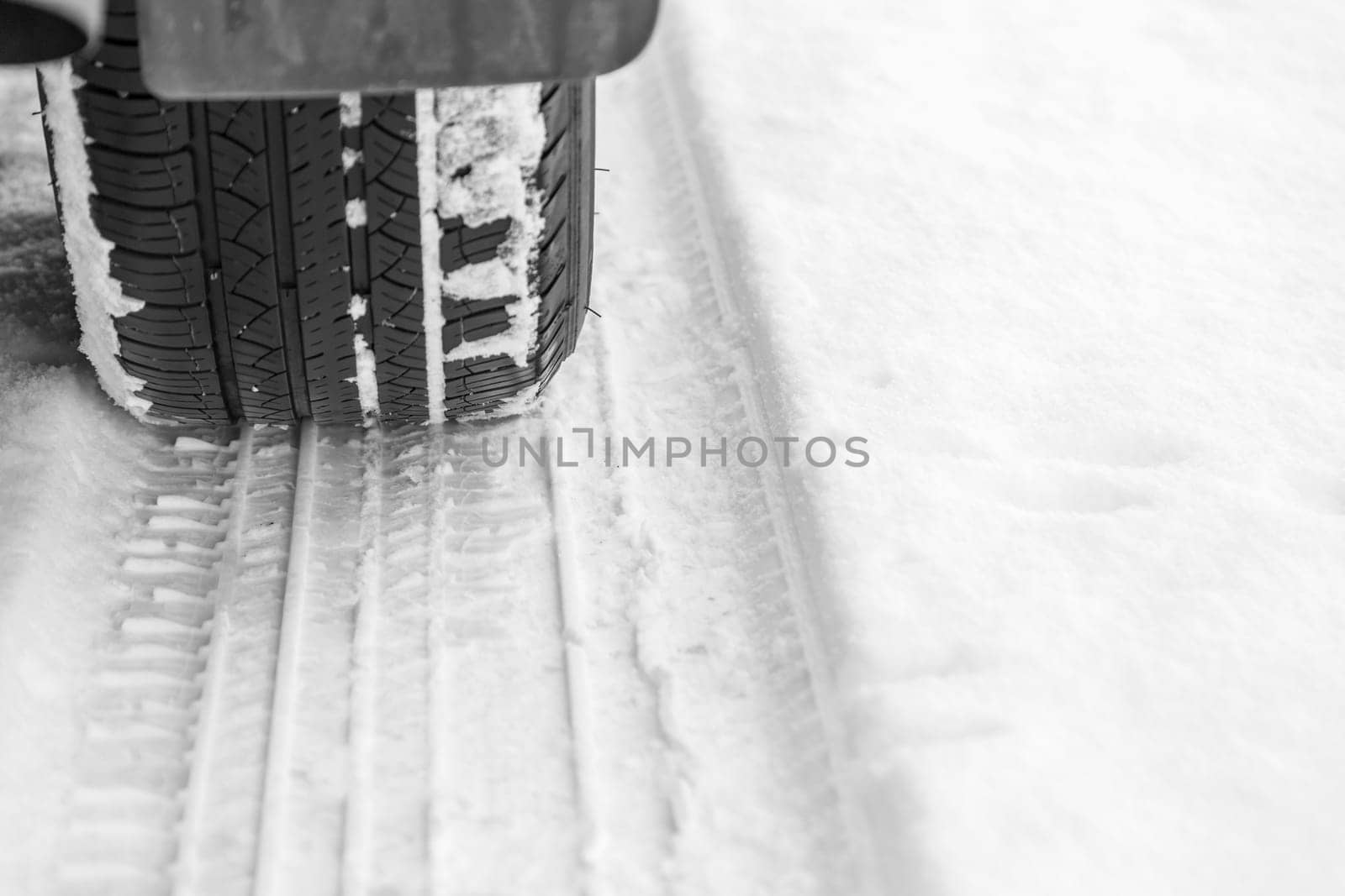 Car tire on snowy winter road