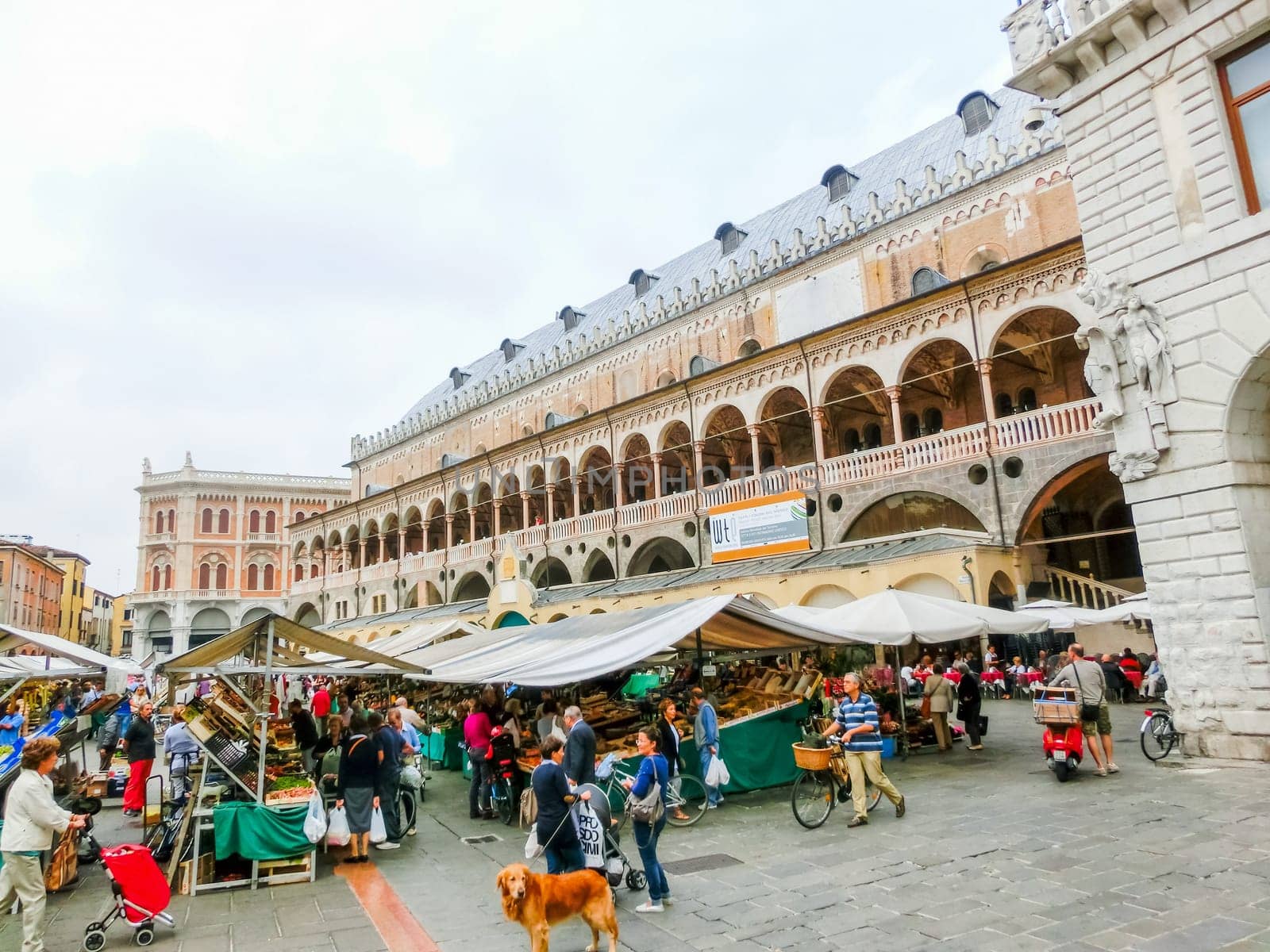 Padua, Italy - September 19, 2014: Scene of Palazzo della Ragione with local market and tourists, in Padua, Veneto, Italy