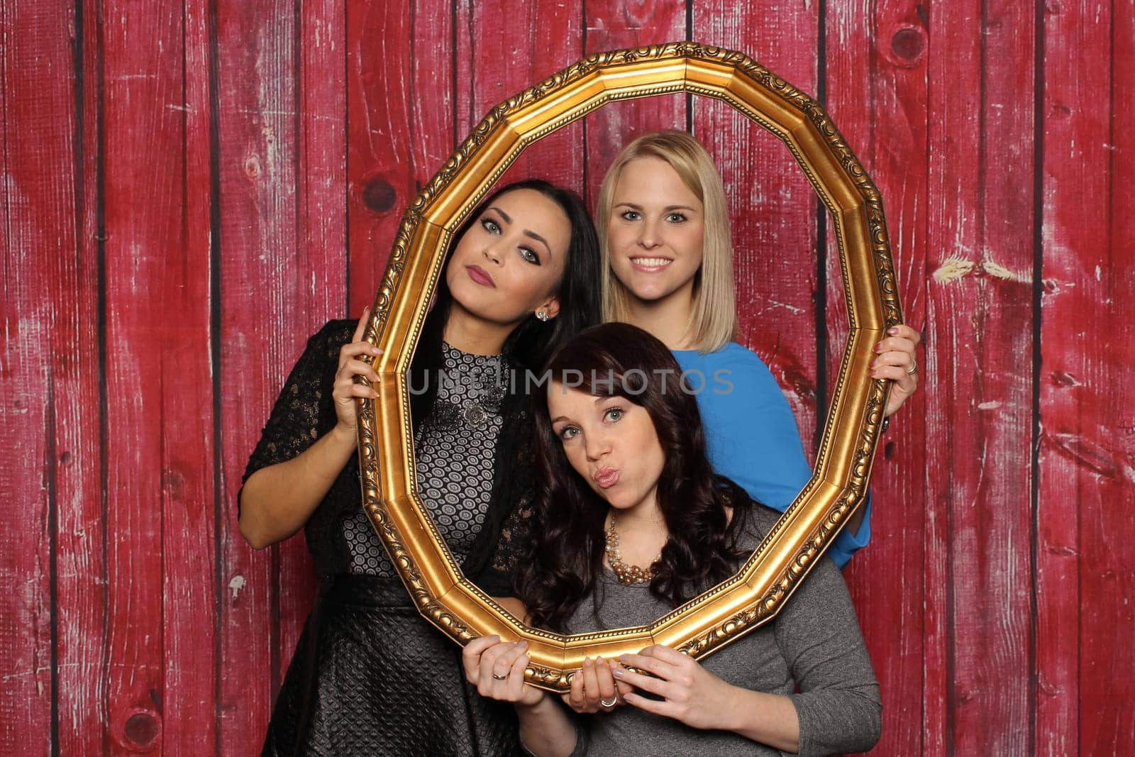 3 girls look through a picture frame