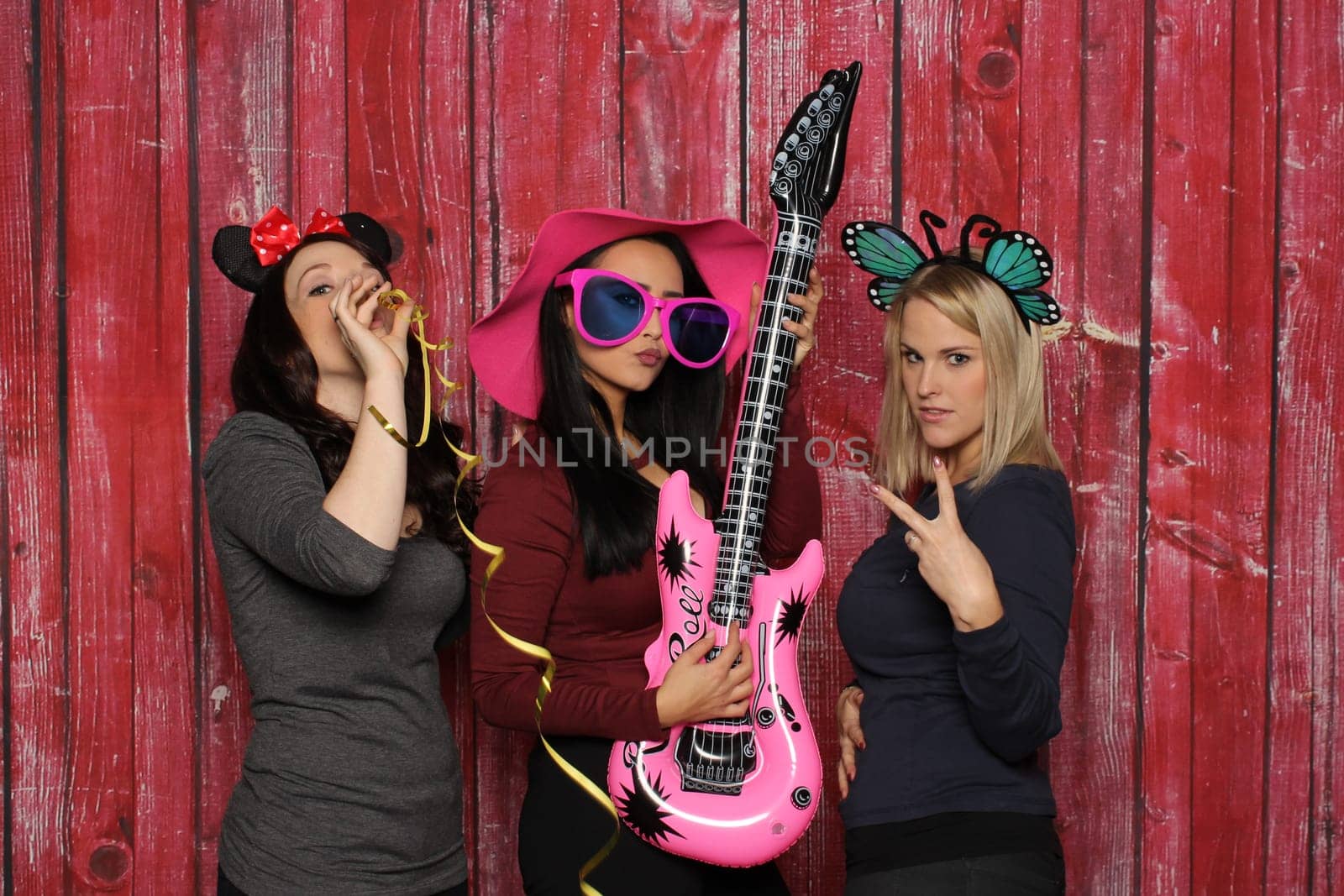 3 girls have fun with a photo booth