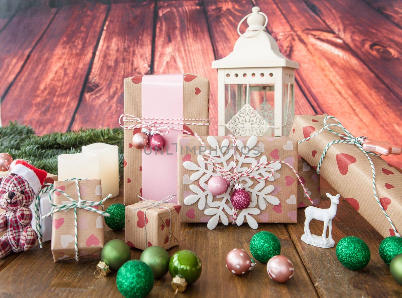 Small gifts and colorful Christmas decorations on rustic wood