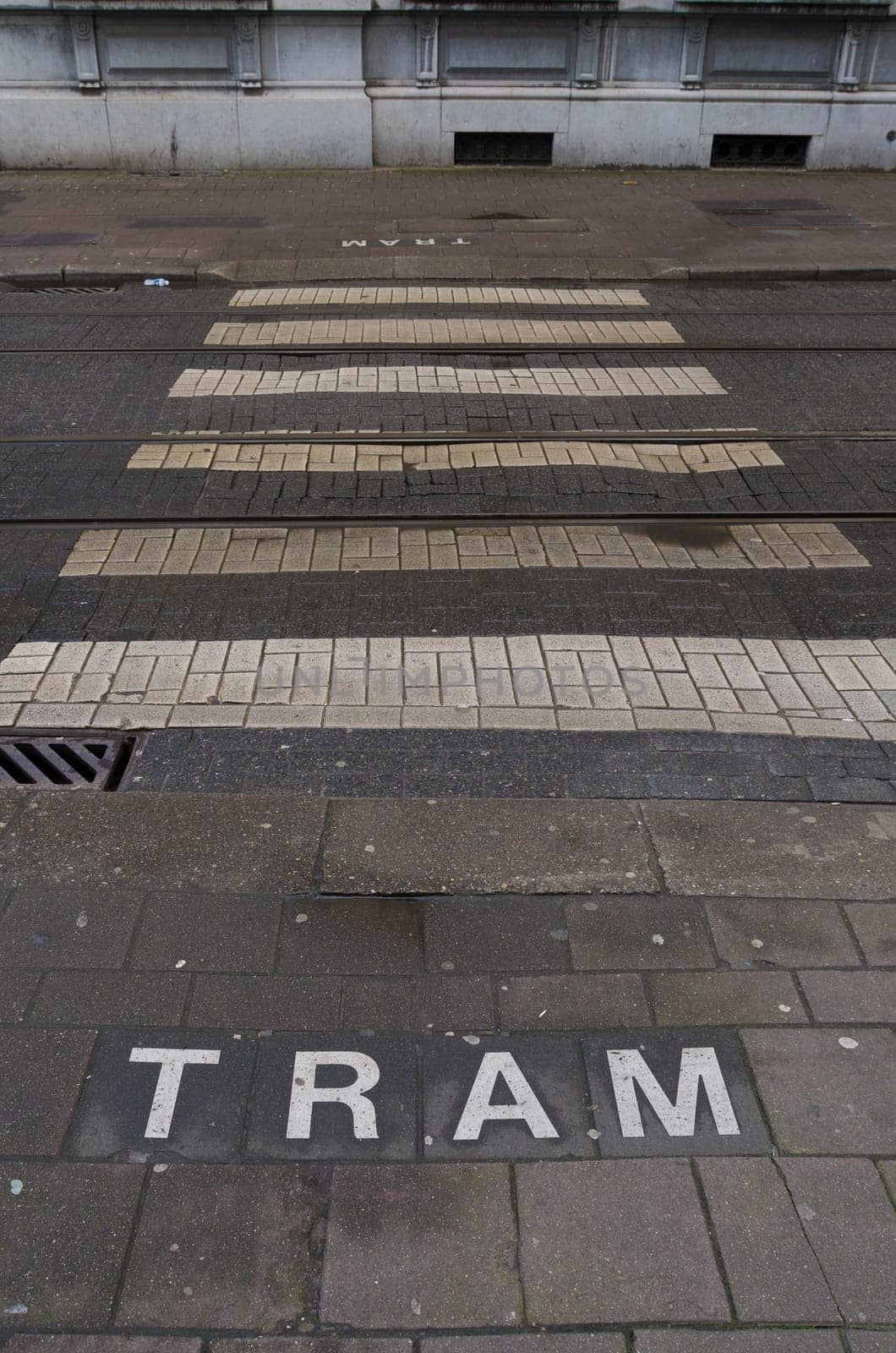 pedestrian crossing with tram warning in the center of antwerp, belgium