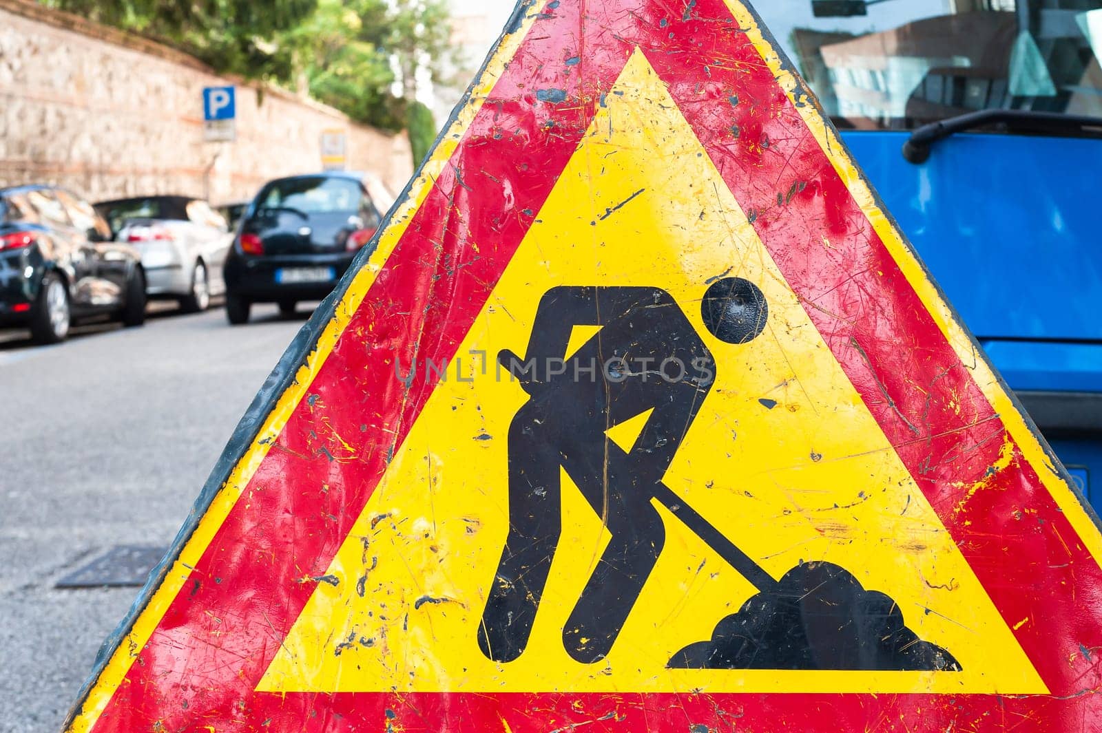 Road signs in a street under reconstruction symbol.