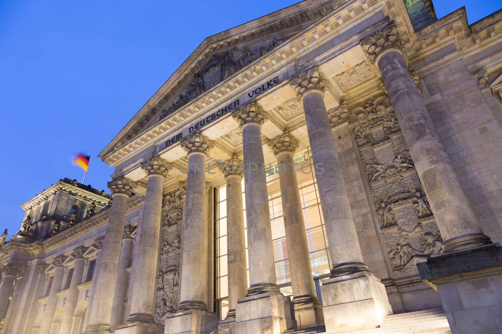 View of famous Reichstag building, seat of the German Parliament ,Deutscher Bundestag, illuminated in dusk, Berlin Mitte district, Germany.