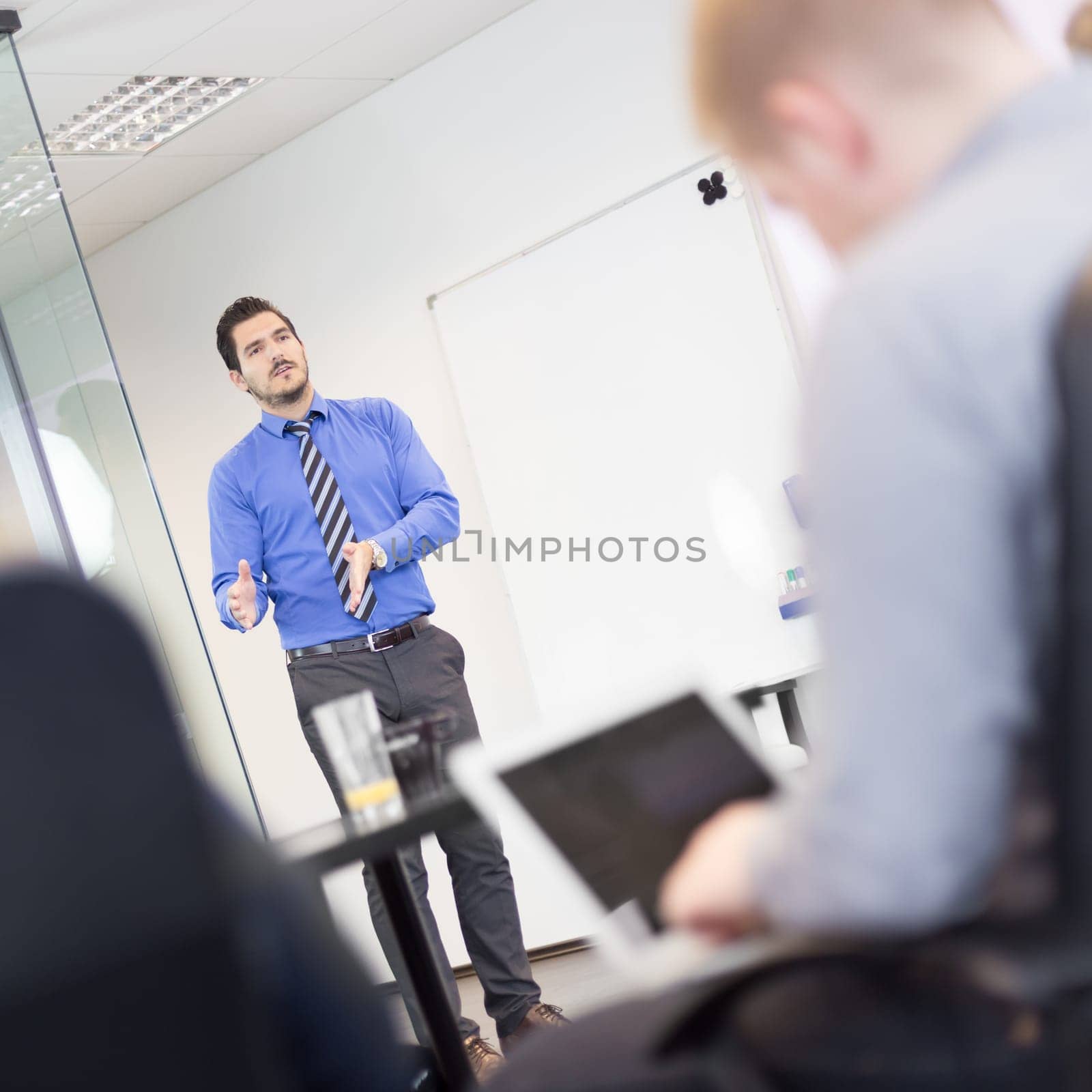 Workplace in modern office with business people brainstorming. Businessman working on laptop during the meeting.