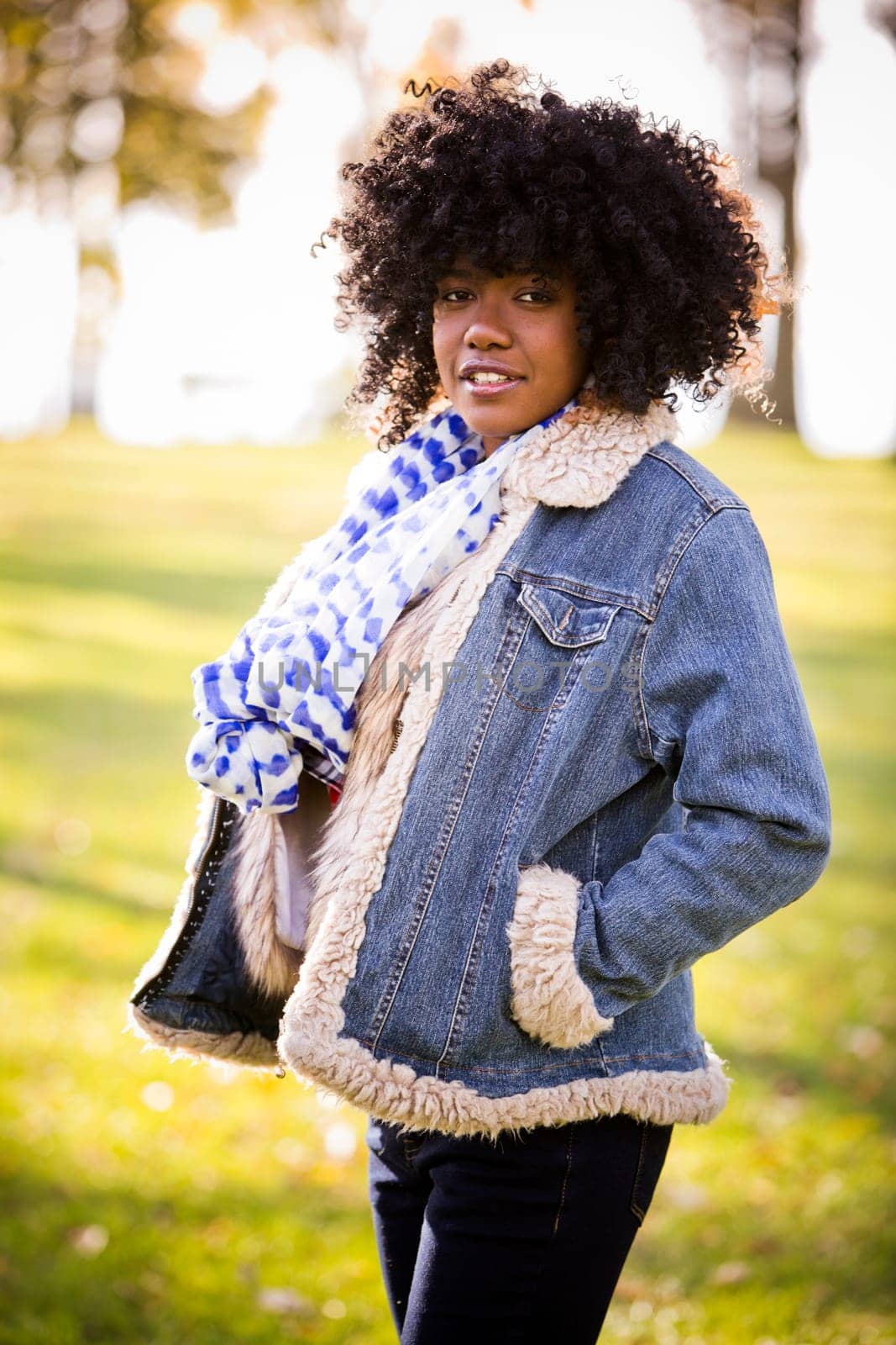 ethnic woman wearing fashion fall outfit outdoors int he park