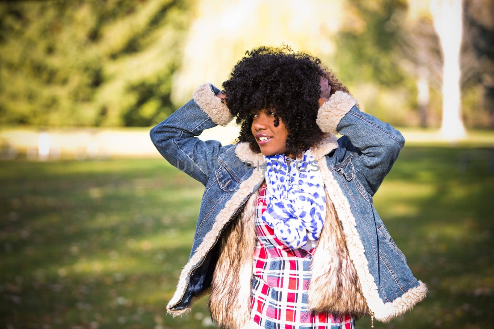 ethnic woman wearing fashion fall outfit outdoors int he park