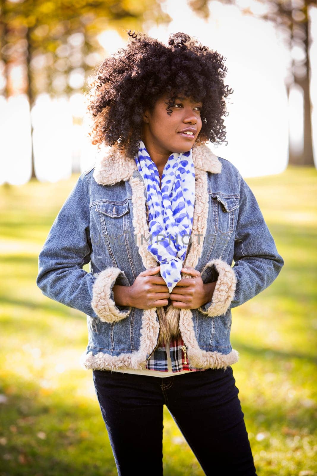 ethnic woman wearing fashion fall outfit outdoors int he park