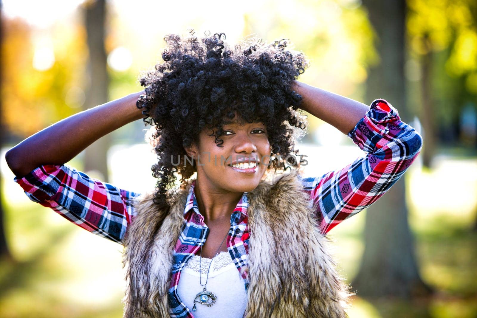 ethnic woman wearing fashion fall outfit outdoors int he park